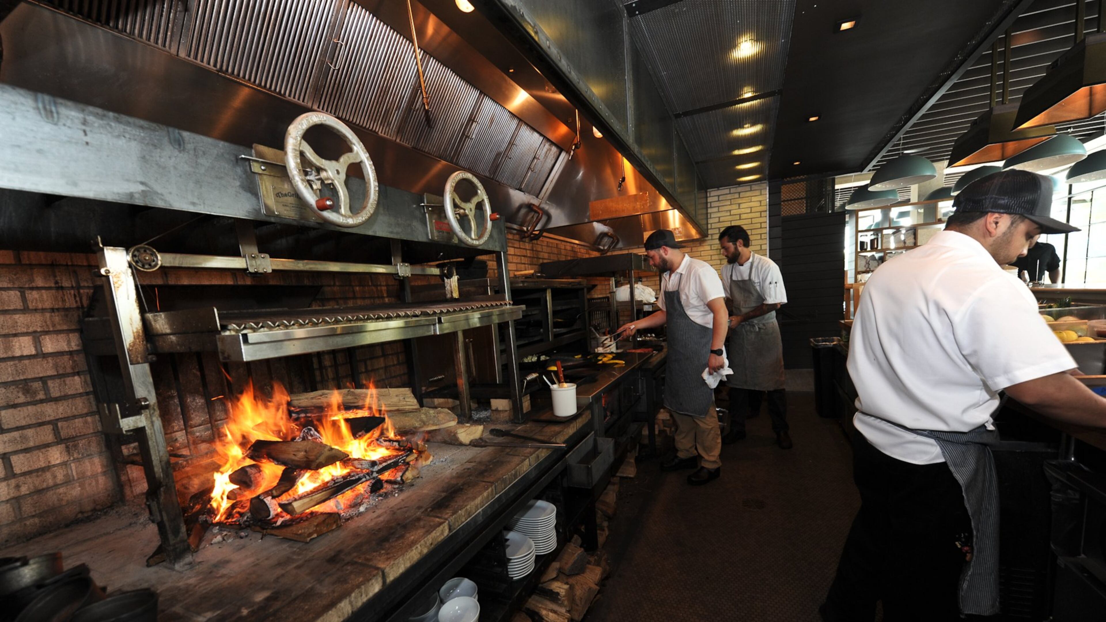 The focal point at King + Duke is a massive open hearth fueled by crackling firewood and hardwood charcoal. (Becky Stein for The Atlanta Journal-Constitution)