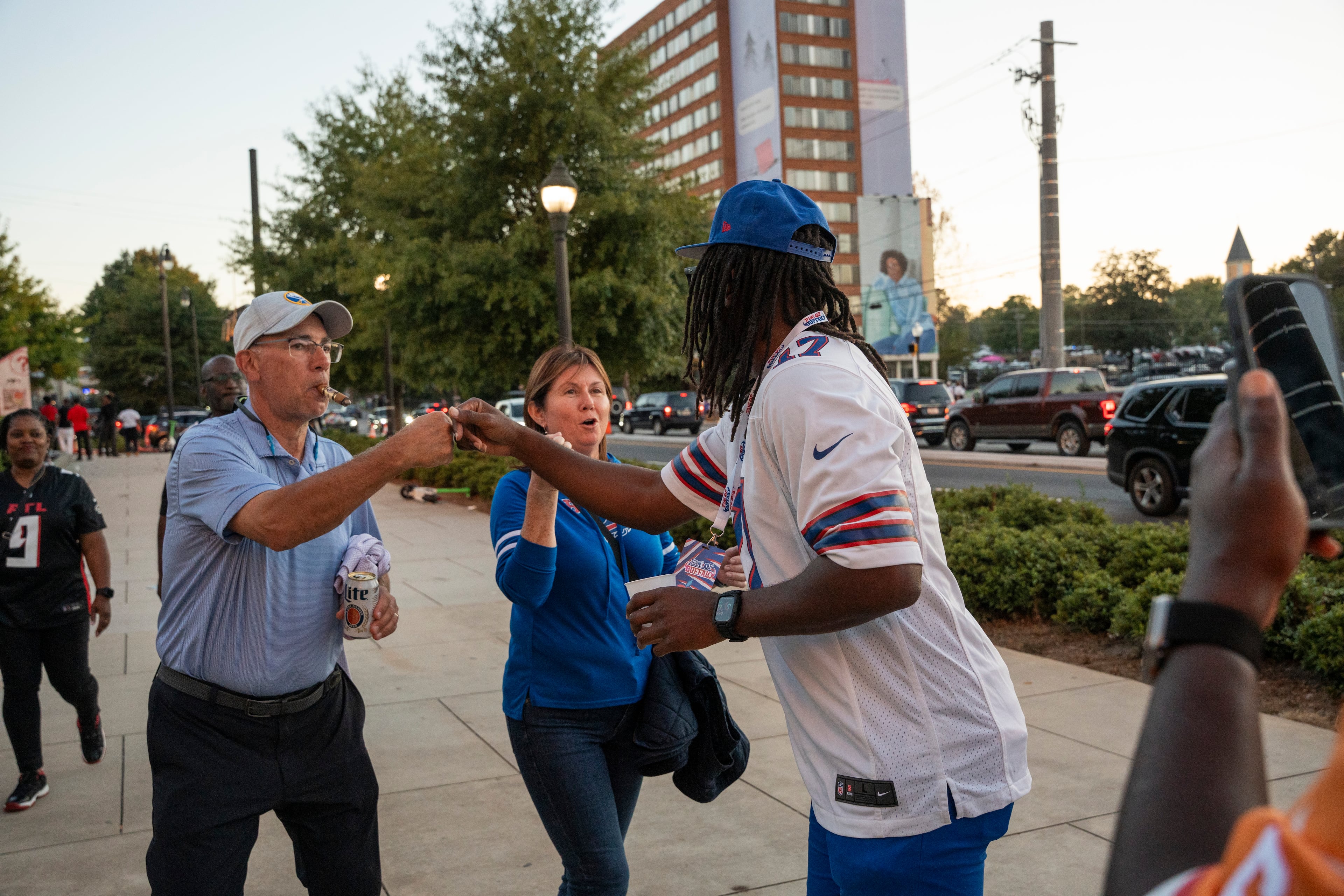 A Bills fan fist bumps a passersby while proclaiming that Buffalo is going to win before Monday night’s game outside Mercedes-Benz Stadium on Oct. 13, 2025, in Atlanta. (Olivia Bowdoin for the AJC)