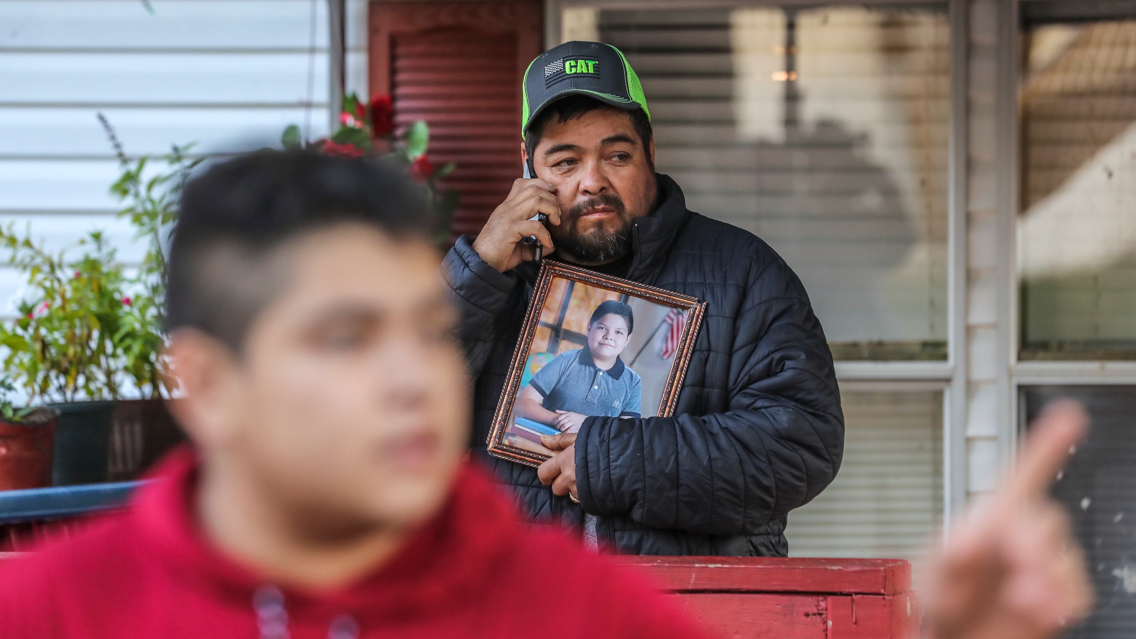October 16, 2020 Clayton County: Santiago Zavala (center) holds a photo of his slain 13-year old son Brayan on Friday, Oct. 16, 2020 as Jesus Zavala (left) said he had no warning before his 13-year-old brother was shot and killed in front of him Thursday night in their front yard in Clayton County. The two were working on a lawn mower outside their home on Willow Lane, located in a mobile home community off Ga. 85 outside Riverdale. The elder brother barely noticed when a Chevrolet HHR pulled up to his neighbor’s house and a man climbed out, he said. “The shooter didn’t even say I want your money, or this is a robbery or I’m assaulting you,” Zavala, 16, told The Atlanta Journal-Constitution from outside his home on Friday. “He just came, stood there (in) silence and shot my brother. Just for killing.” Brayan Zavala was dead when Clayton County police officers arrived about 9:15 p.m. The Kendrick Middle School student was not a troublemaker, his brother said. He was a typical kid who spent most days with his family since the start of the coronavirus pandemic. Work, then home. Homework, then rest.
A Clayton County police spokesman on Thursday said investigators have yet to determine a connection between Brayan and the gunman. Investigators collected evidence at the mobile home park community overnight and declined to provide more information at the scene, Channel 2 Action News reported. The family has started a GoFundMe fundraiser to take Brayan’s body back to Mexico to be buried. (John Spink / John.Spink@ajc.com)