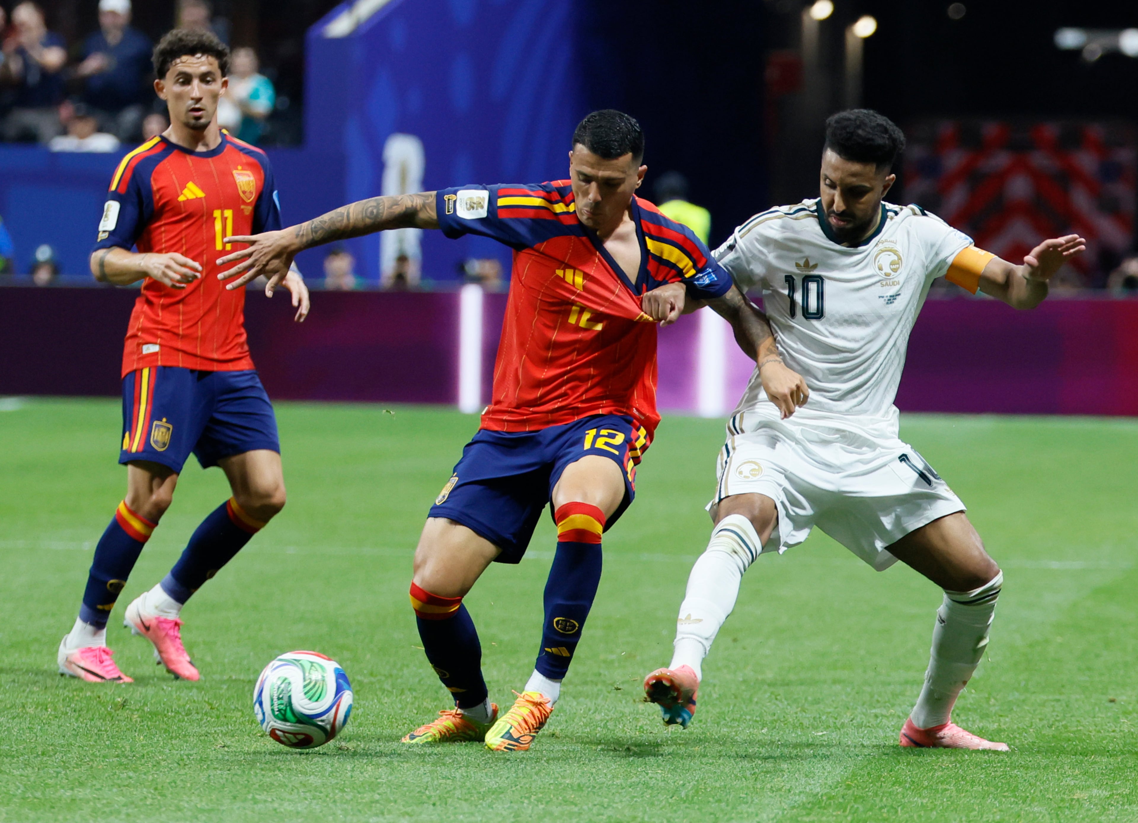 Spain's Pedro Porro (center) battles Saudi Arabia's Salem Al-Dawsari (right) as Spain's Yeremy Pino looks on during the second half of the Spain vs. Saudi Arabia World Cup match Sunday, June 21, 2026, at Atlanta Stadium. (Miguel Martinez/AJC)