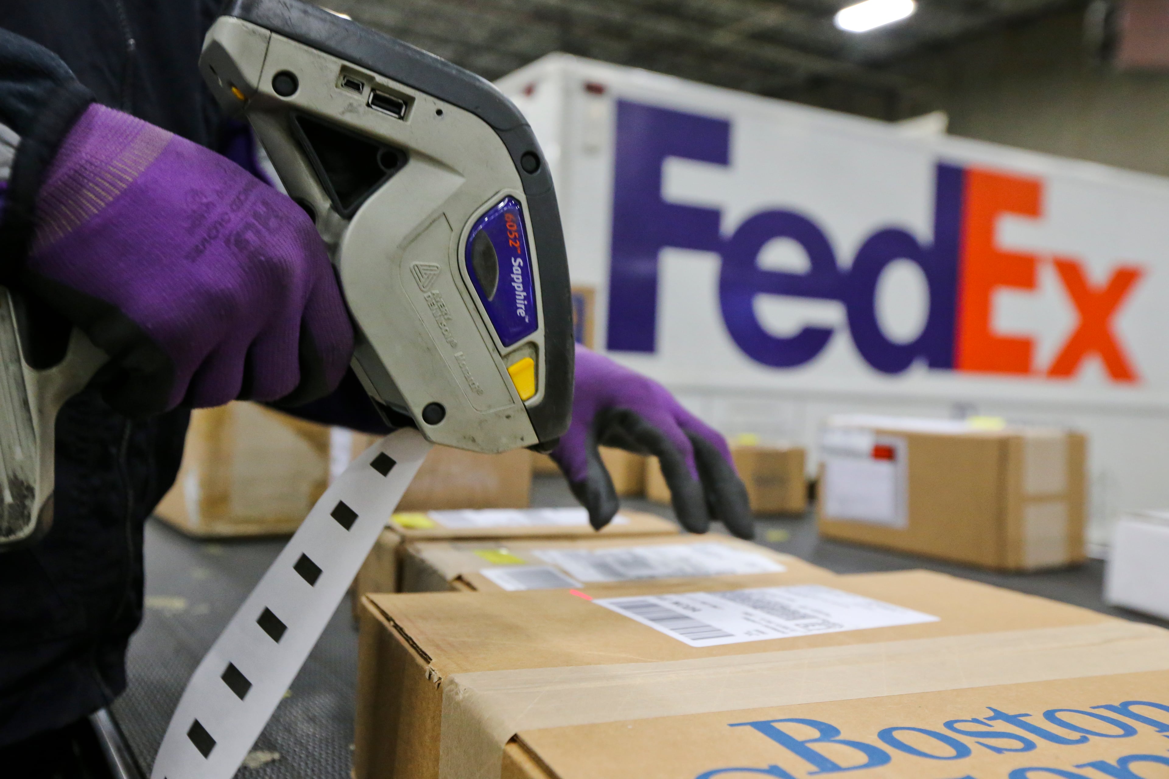 December 15, 2014 Marietta: Lee Ivory scans packages for delivery on Monday, Dec. 15, 2014. The FedEx Express Marietta Facility at 2049 Franklin Way in Marietta saw a peak day on Monday, Dec. 15, 2014 as 123 FedEx vehicles and 45 rental trucks moved 21,000 packages from the facility. With an increase of online sales the company hired temps and worked employees with double shifts to keep up with the demand. JOHN SPINK / JSPINK@AJC.COM