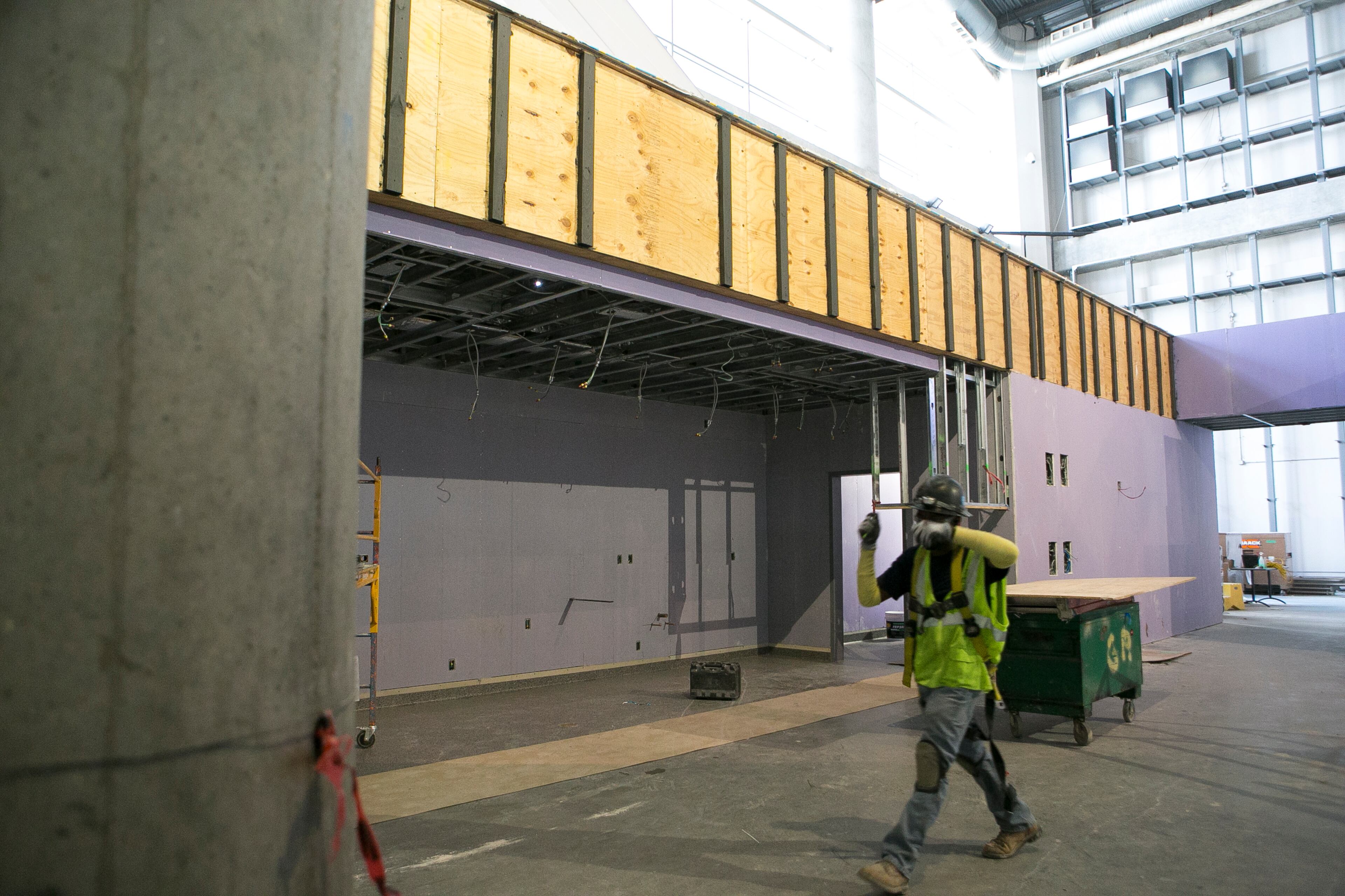 A construction worker walks through the Atlanta Social area during a guided media tour through the in-progress renovations at the State Farm Arena in Atlanta, Ga., on Thurs., Sept. 20, 2018. The renovations, which total $192.5 million, are on track to be completed by the arena's scheduled open house on October 20. The current rate of progress is about $1 million of work per day, according to Brett Stefansson, Atlanta Hawks executive vice president and general manager of State Farm Arena. (CASEY SYKES, CASEYLANESYKES@GMAIL.COM)