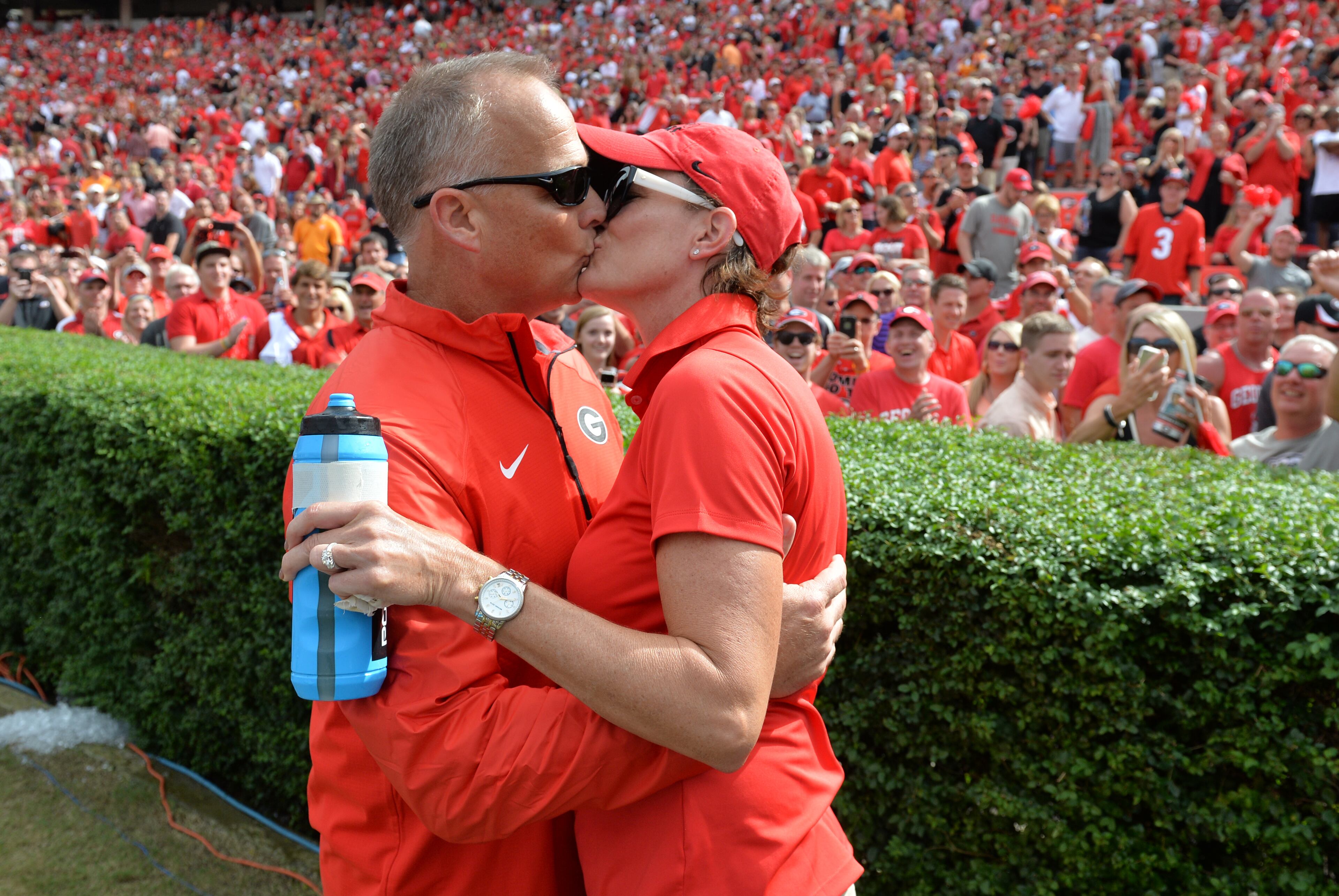A walk down memory lane with UGA coach Mark Richt, who is out after 15 seasons.In this photo, Richt celebrates with his wife, Katharyn, after the Bulldogs defeated Tennessee at Sanford Stadium on September 27, 2014. Richt's wife worked during the game filling water bottles for the players. BRANT SANDERLIN / BSANDERLIN@AJC.COM
