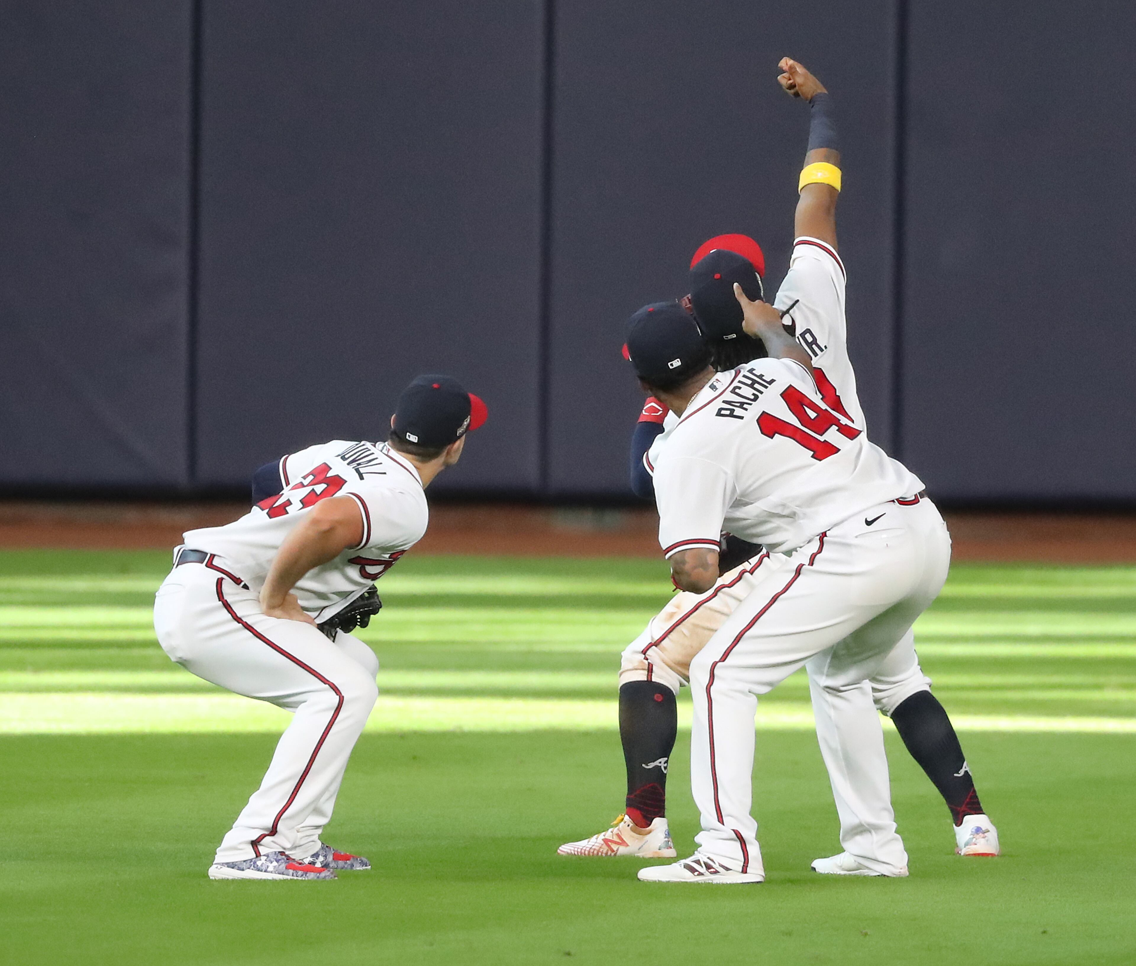 Braves (from left) Adam Duvall, Cristian Pache and Ronald Acuna pretend to take a selfie while celebrating a 9-5 victory over the Miami Marlins during Game 1 of a National League Division Series at Minute Maid Park on Tuesday, Oct 6, 2020 in Houston. “Curtis Compton / Curtis.Compton@ajc.com”