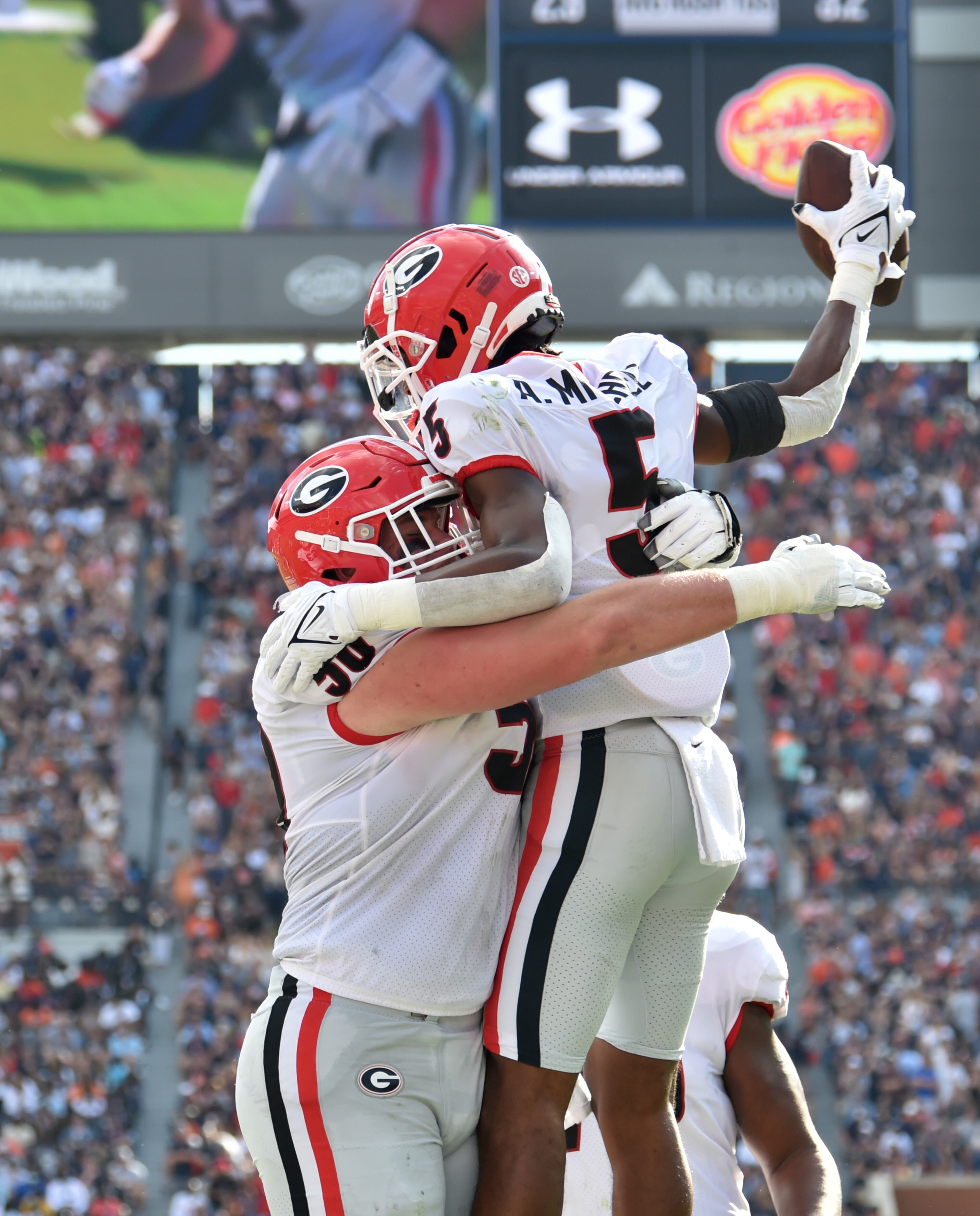 Georgia wide receiver Adonai Mitchell (5) celebrates with teammates after scoring a touchdown during the first half. (Hyosub Shin / Hyosub.Shin@ajc.com)