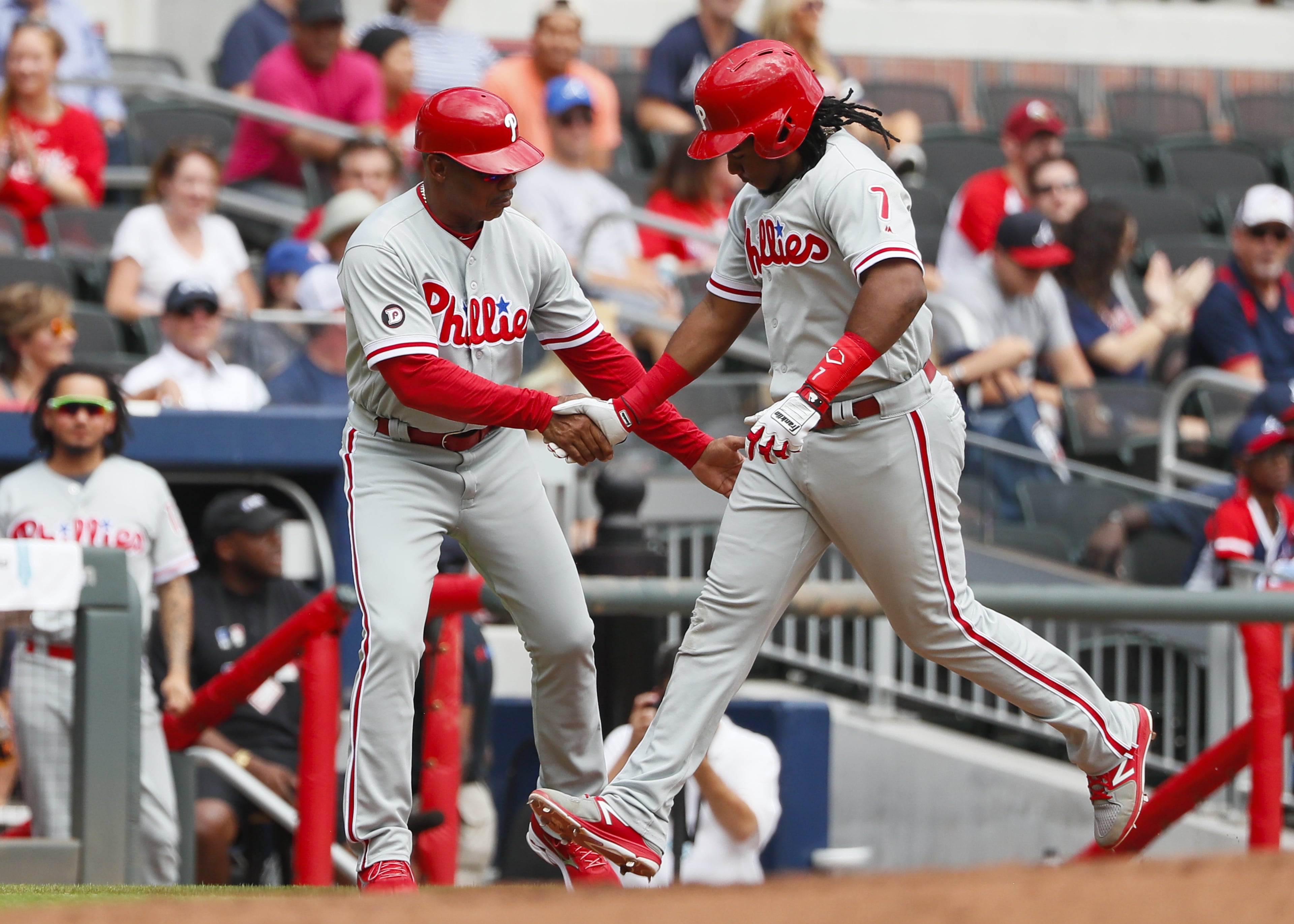 ATLANTA, GA - SEPTEMBER 24: Maikel Franco #7 of the Philadelphia Phillies rounds third and shakes hands with third base coach Juan Samuel #8 after hitting a solo home run in the fifth inning of an MLB game against the Atlanta Braves at SunTrust Park on September 24, 2017 in Atlanta, Georgia. The Philadelphia Phillies won the game 2-0. (Photo by Todd Kirkland/Getty Images)