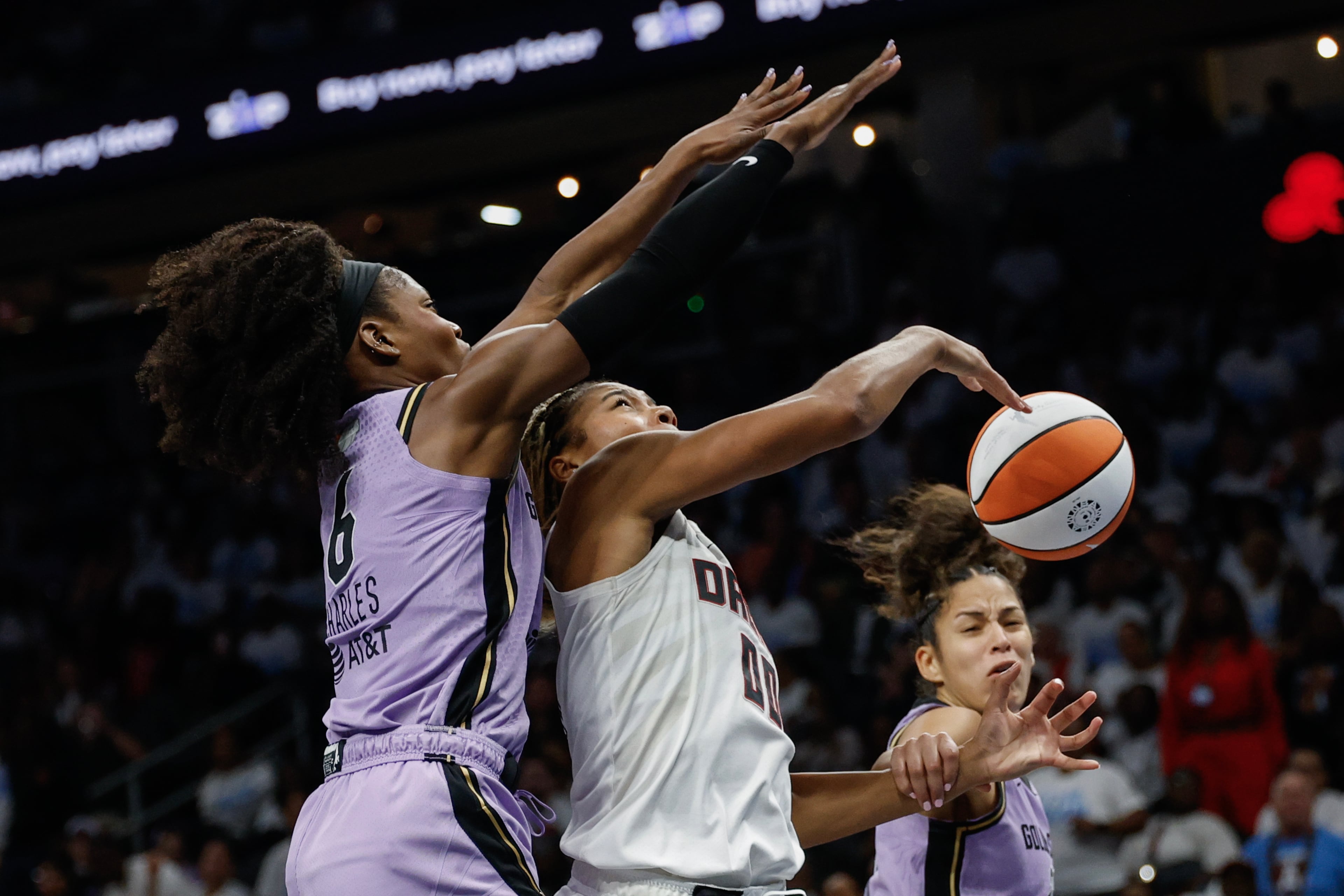 Atlanta Dream forward Naz Hillmon (center) is defended by Golden State Valkyries guard Kaila Charles (left) and guard Veronica Burton during the second half of Game 4 of the WNBA Finals between the Atlanta Dream and the Golden State Valkyries, Saturday, Oct. 24, 2026, in Atlanta. (Erik S. Lesser for the AJC)