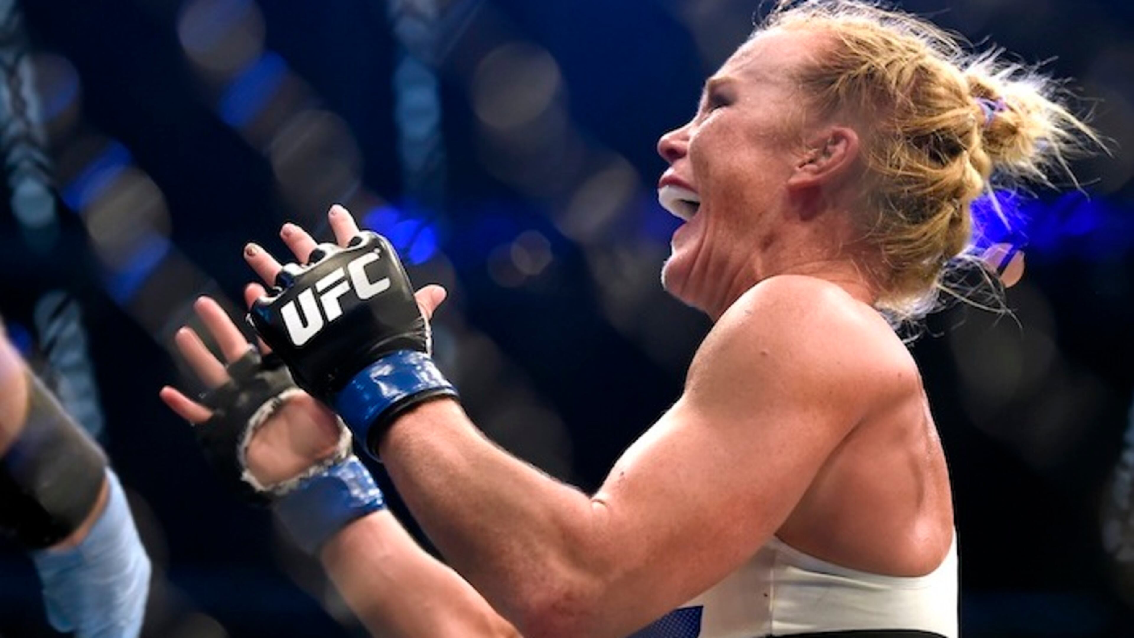 Holly Holm celebrates after defeating Ronda Rousey during thier UFC 193 Bantamweight title fight in Melbourne, Australia, Sunday, Nov. 15, 2015. (AP Andy Brownbill)