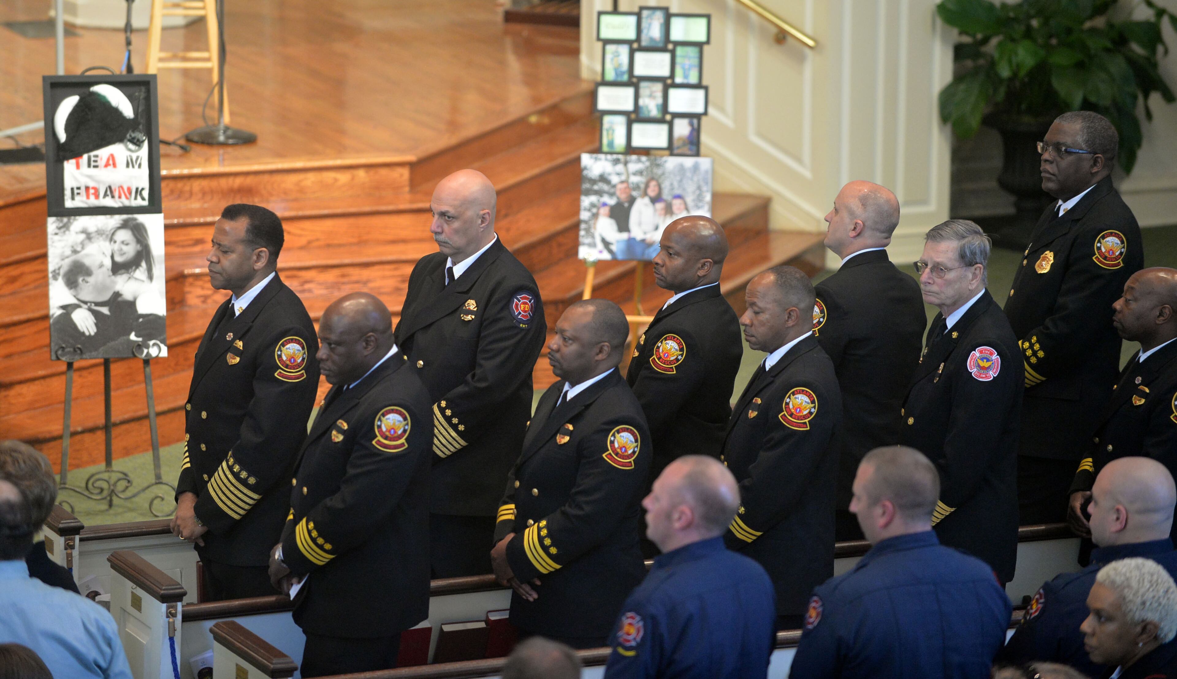 Atlanta Fire Rescue officials, including Fire Chief Kelvin Cochran, rear left, and firefighters joined with family and friends during the funeral of AFR Sgt. Frank Guinn at Peachtree Road Presbyterian Church, Thursday, April 17, 2014.