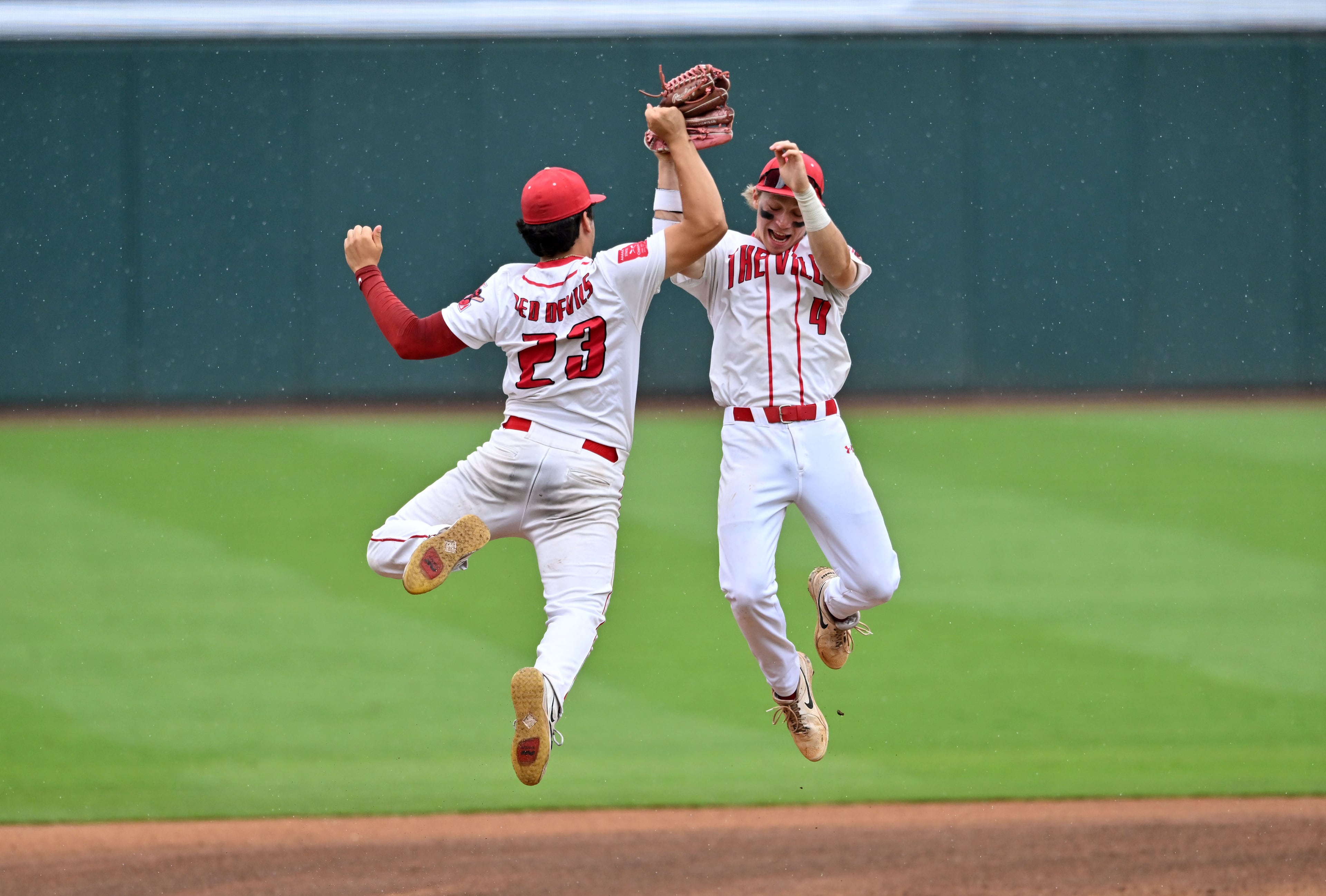 Loganville outfielders Kayden Quiros (left) and Aiden Gorvett celebrate after beating Pope during Game 1 of the GHSA Class 5A baseball state championship series Monday, May 25, 2026, at Gwinnett Field in Lawrenceville. (Hyosub Shin/AJC)