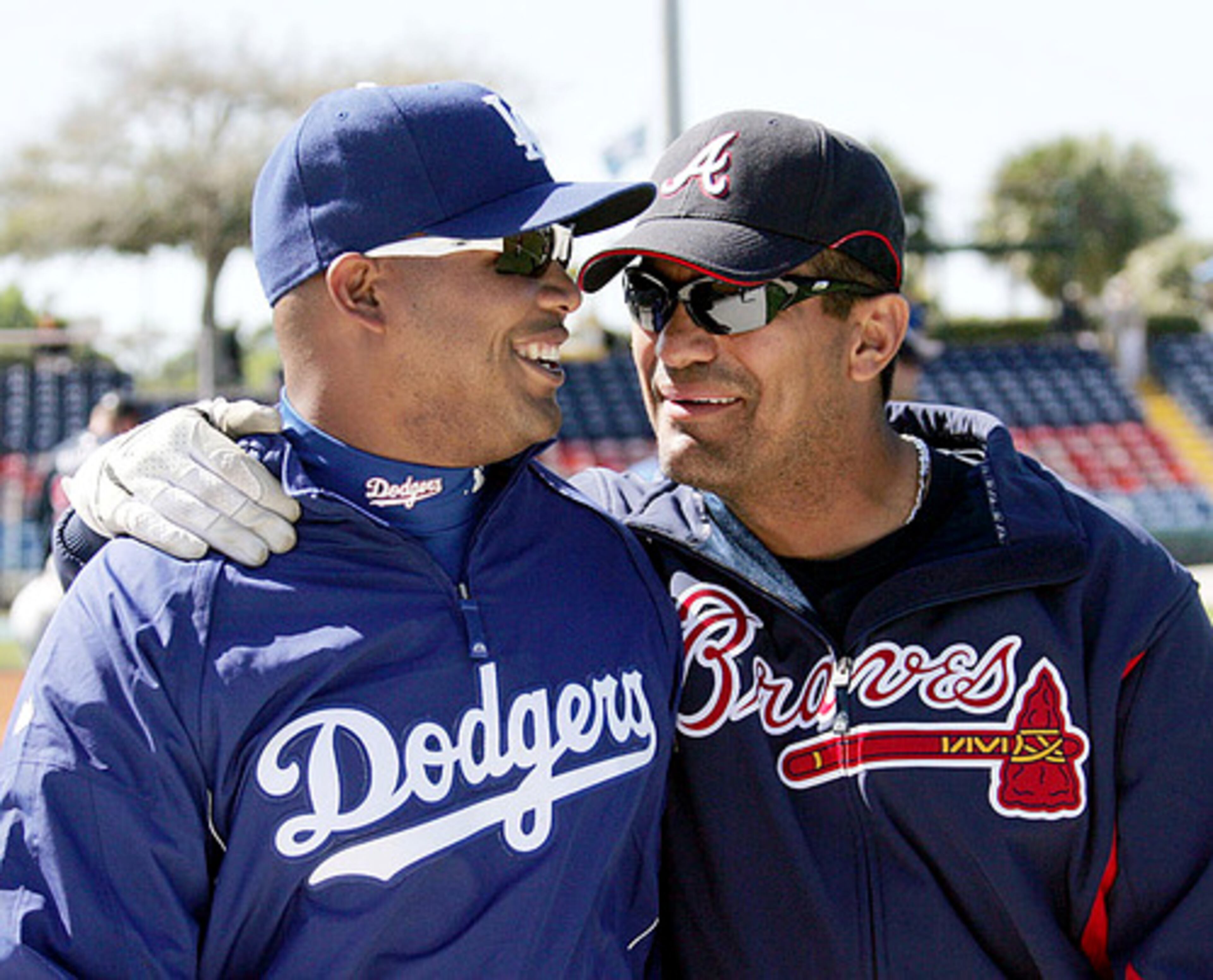 Braves coach Eddie Perez gives Jones some sage advice.