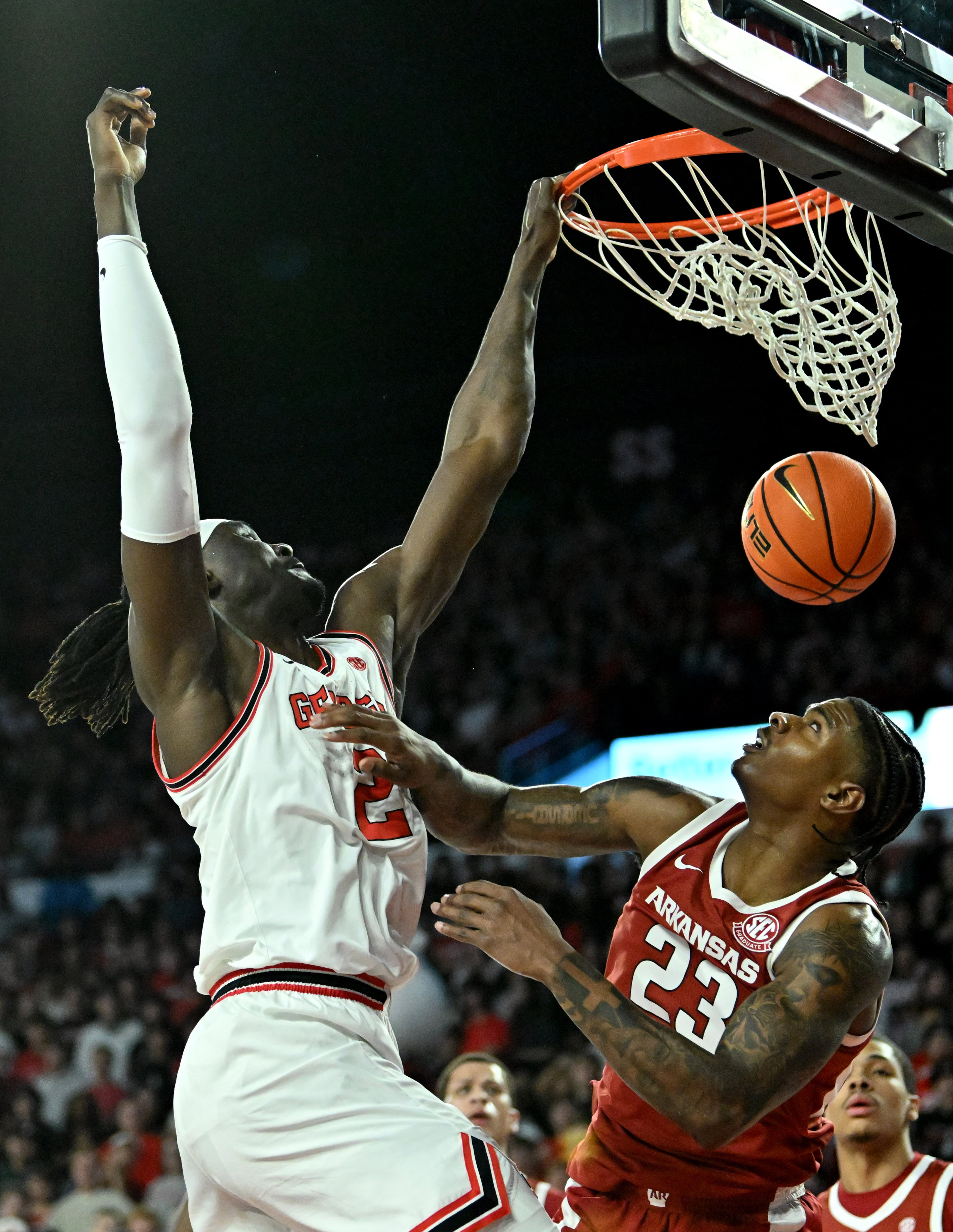 Georgia center Somto Cyril (left) dunks over Arkansas forward Nick Pringle on Saturday, Jan. 17, 2026, at Stegeman Coliseum in Athens. Cyril is averaging 9.6 points, 6.1 rebounds and 2.7 blocks per game. (Hyosub Shin/AJC)