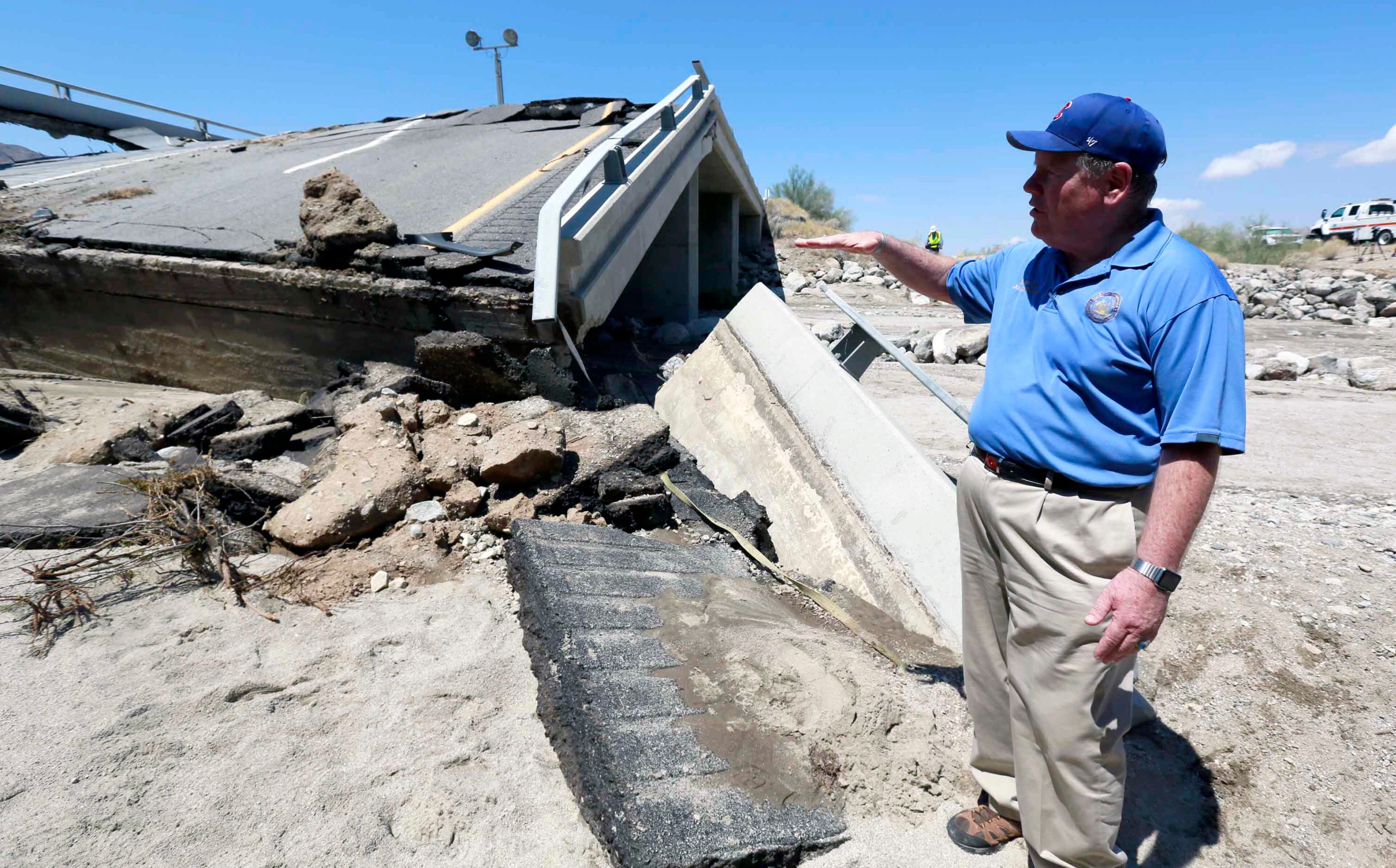 Riverside County Supervisor John J. Benoit talks to the media about a collapsed bridge that was washed out along Interstate 10 in Southern California, Monday, July 20, 2015. All traffic along one of the major highways connecting California and Arizona was blocked indefinitely when the bridge over a desert wash collapsed during a major storm, and the roadway in the opposite direction sustained severe damage. (AP Photo/Nick Ut)