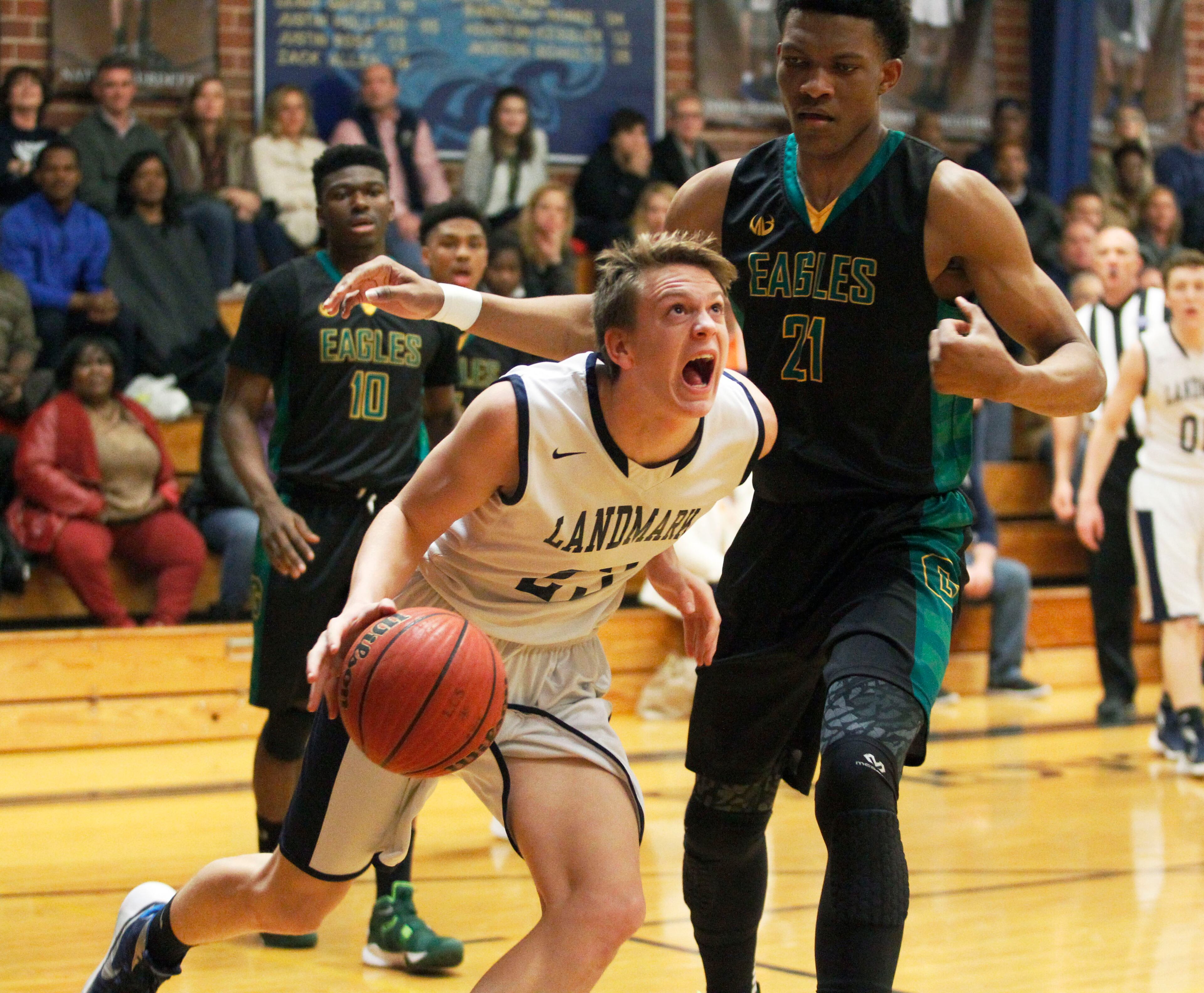 Landmark Christian forward Wix Patton (23) drives to the basket past Greenforest Christian Ikey Obiagu (21) during their game at a high school basketball game at Landmark Christian school Friday, February 5, 2016. TAMI CHAPPELL/SPECIAL TO THE AJC
