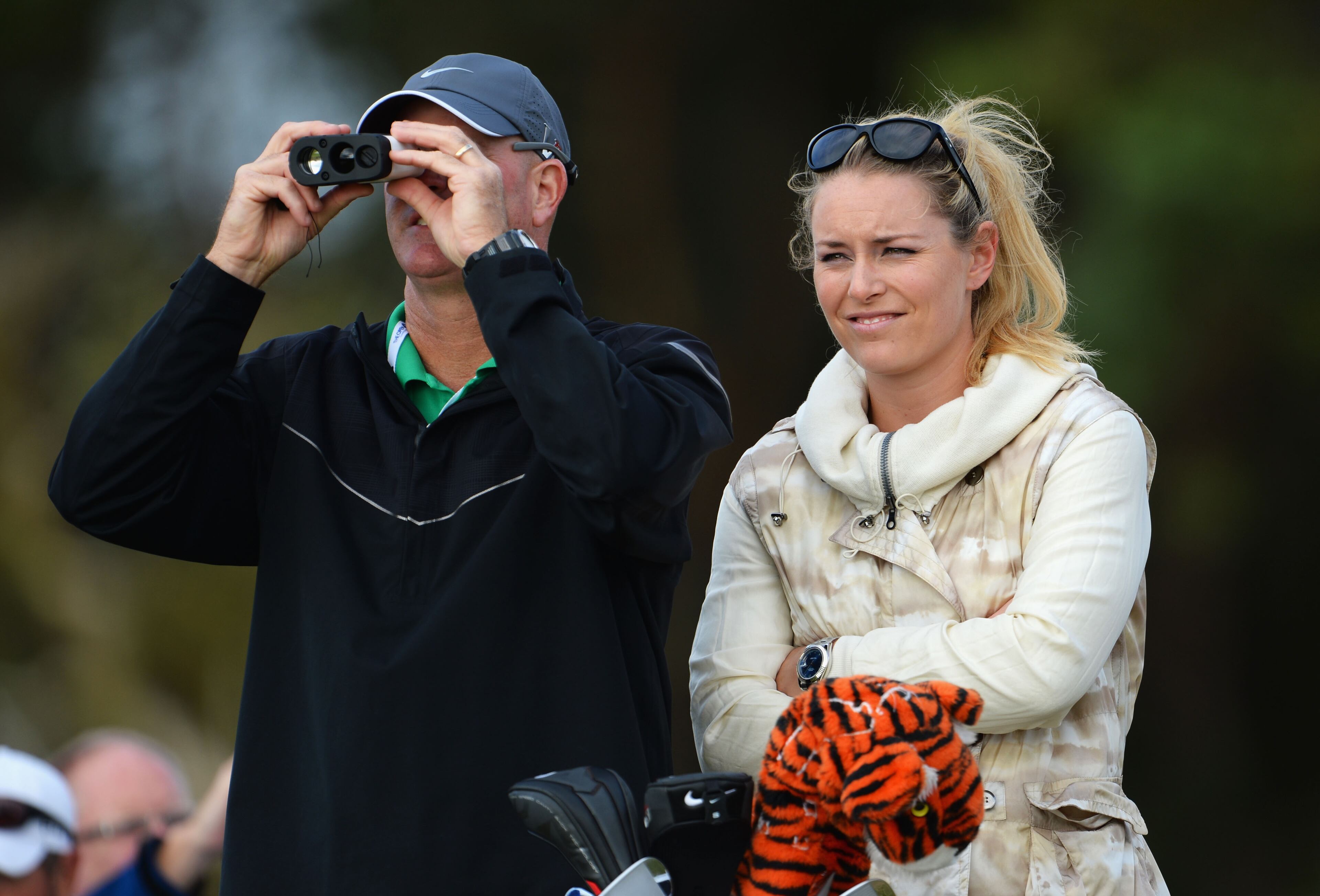 Caddie Joe LaCava for Tiger Woods of the United States stands with skier Lindsey Vonn watches Tiger Woods of the United States ahead of the 142nd Open Championship at Muirfield on July 15, 2013 in Gullane, Scotland. (Photo by Stuart Franklin/Getty Images)