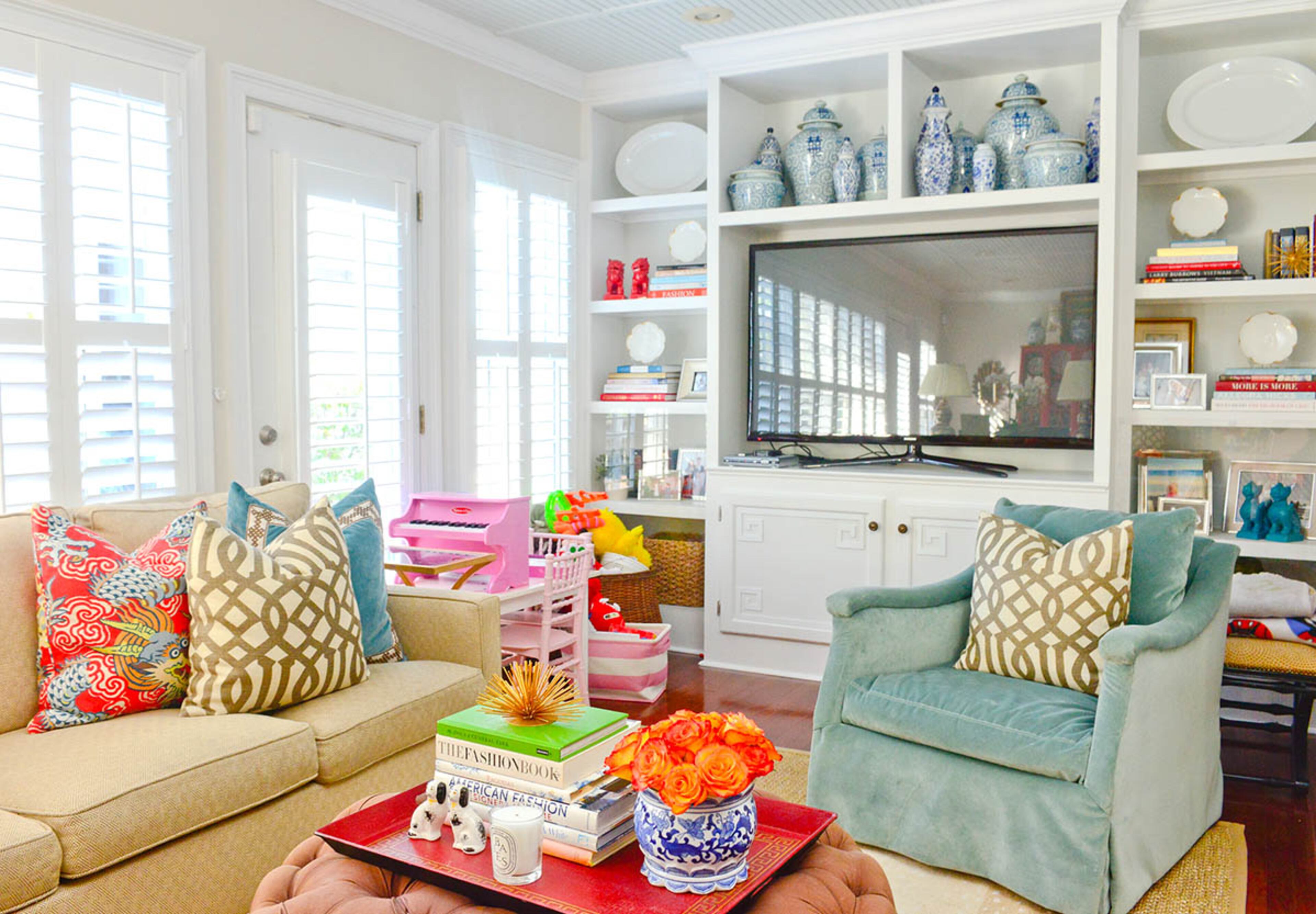 A pale turquoise chair from Lee unites a thread of blue accents in the den, and built-in shelving gives the homeowners plenty of functional and stylish storage. Their friend Mallory Mathison Glenn, who is an Interior designer, had a hand in many of the decor decisions.