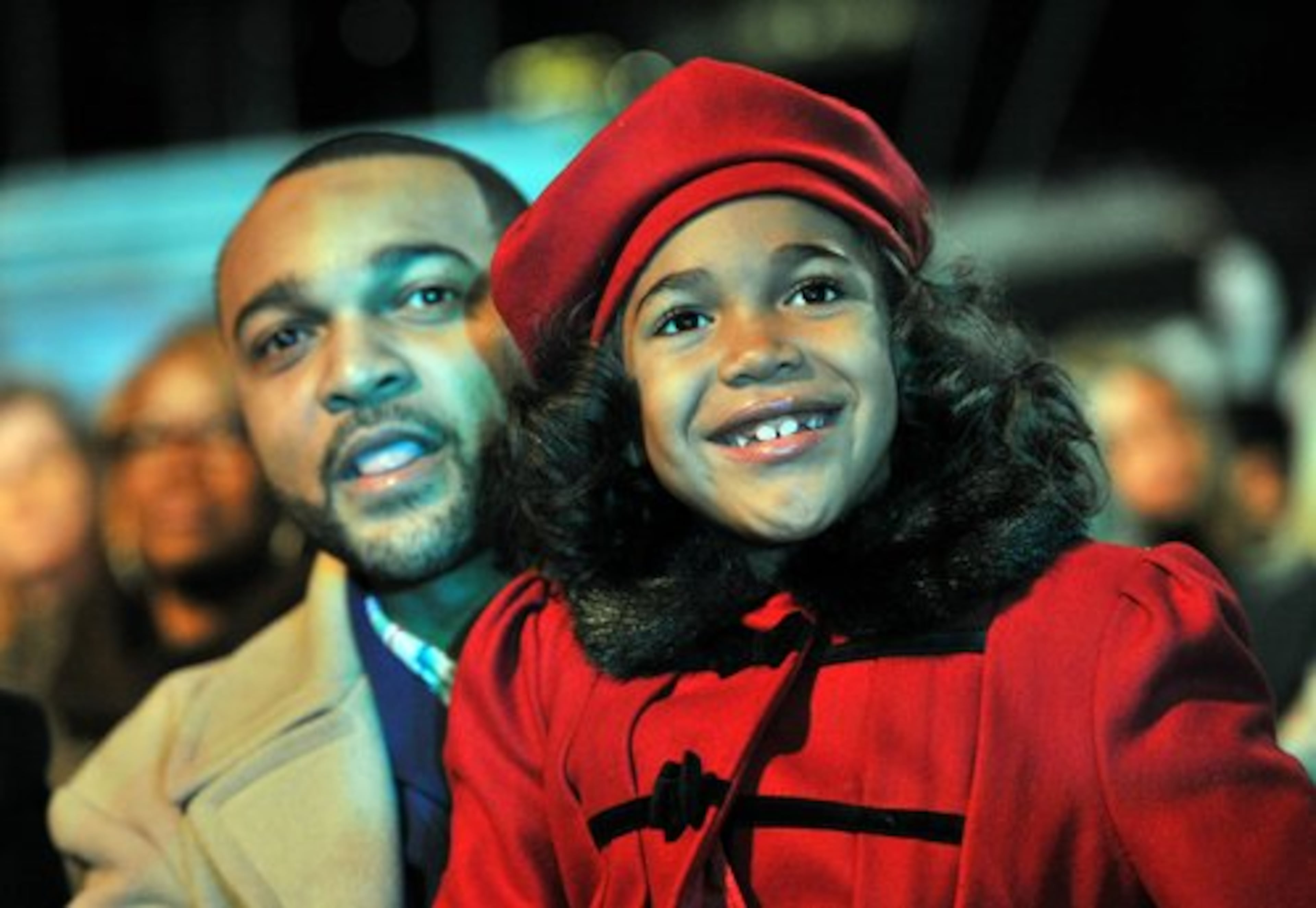 Eric Washington (left), of Marietta, and his 8-year old daughter Gabriele-Simone Washington listen to live performance during the Macy's Great Tree Lighting Show at Lenox Square Mall on Thursday, November 24, 2011. For more than six decades, generations of Atlantans have welcomed the holiday season with the lighting of the Macy's Great Tree.