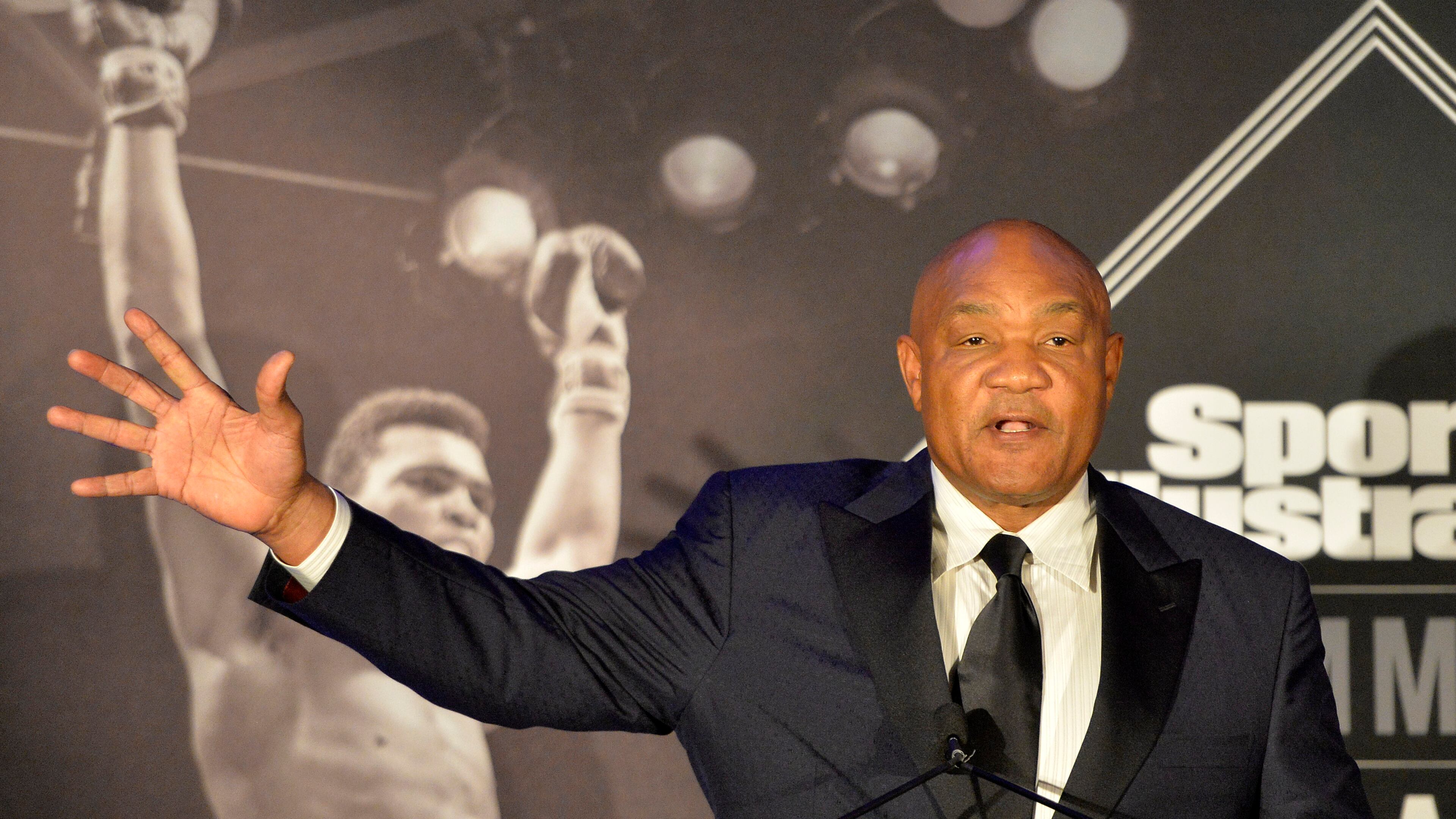 Former heavyweight boxing champion George Foreman tells a story of a young Muhammad Ali to the audience at the Sports Illustrated Legacy Awards Thursday, Oct. 1, 2015, in Louisville, Ky. Sports Illustrated announced that it will dedicate the franchise's Sportsman Legacy Award in the name of boxing legend Muhammad Ali. (AP Photo/Timothy D. Easley)