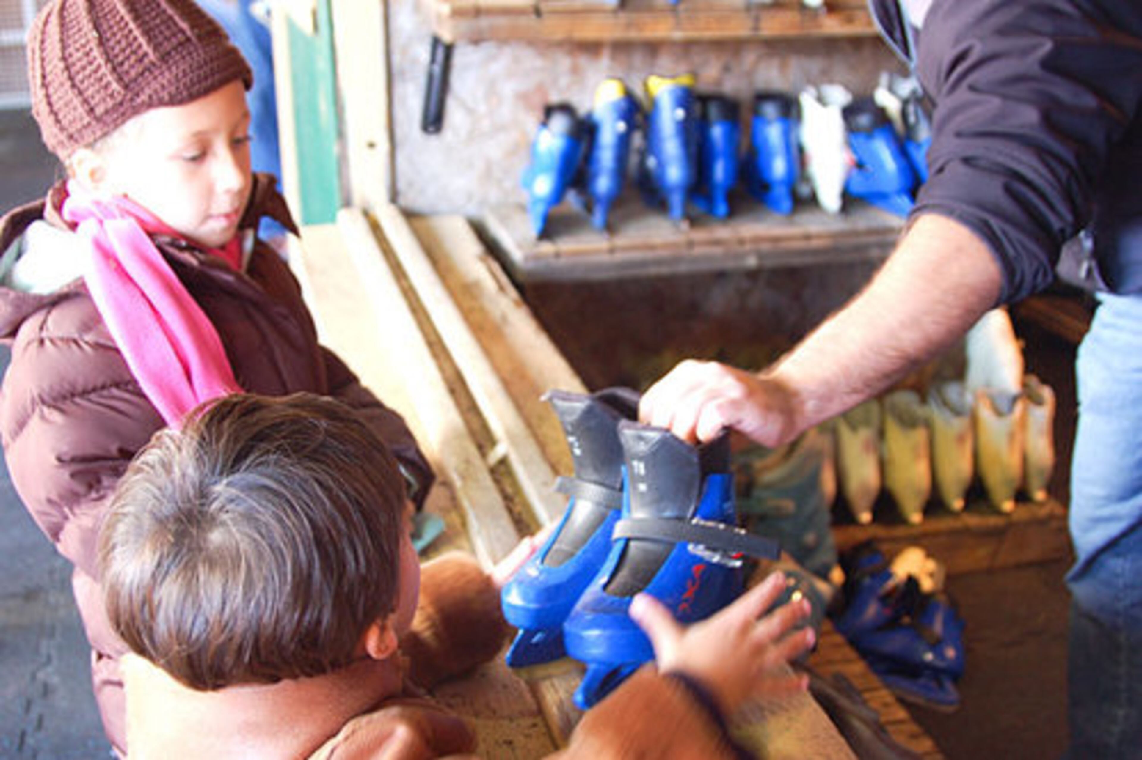 Isabella Rouse, who turned 6 on Saturday, Nov. 15, 2008, takes her little brother, Branch, 2, to exchange his skates for a better fit at the skate rental booth at the rink.