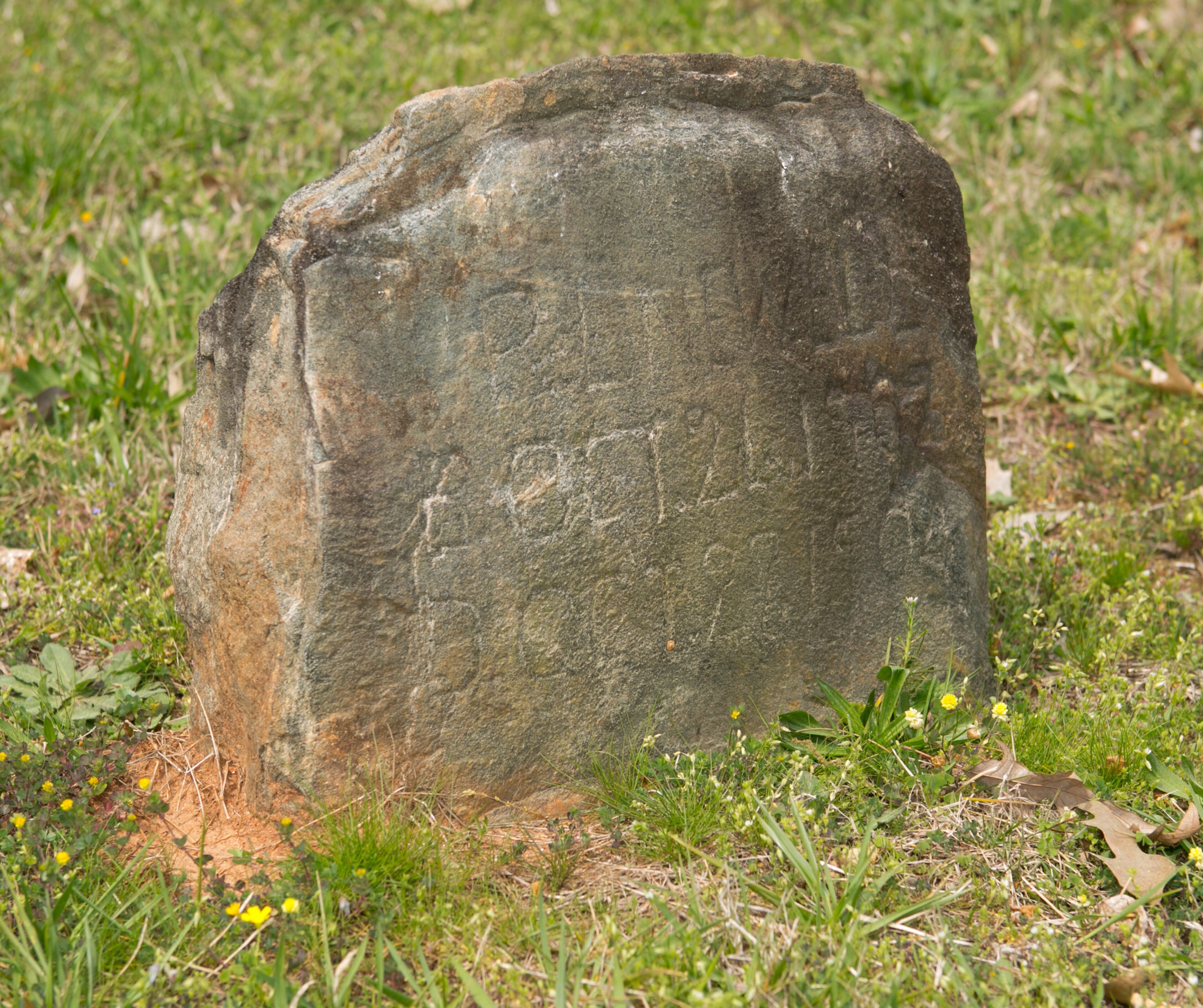 The grave marker for PL Newell is shown at the Pleasant Hill Cemetery Wednesday, March 30, 2016, in Roswell, Ga. The markings read 1902-1904 which makes this grave marker the oldest marker at Pleasant Hill Cemetery. PHOTO / JASON GETZ