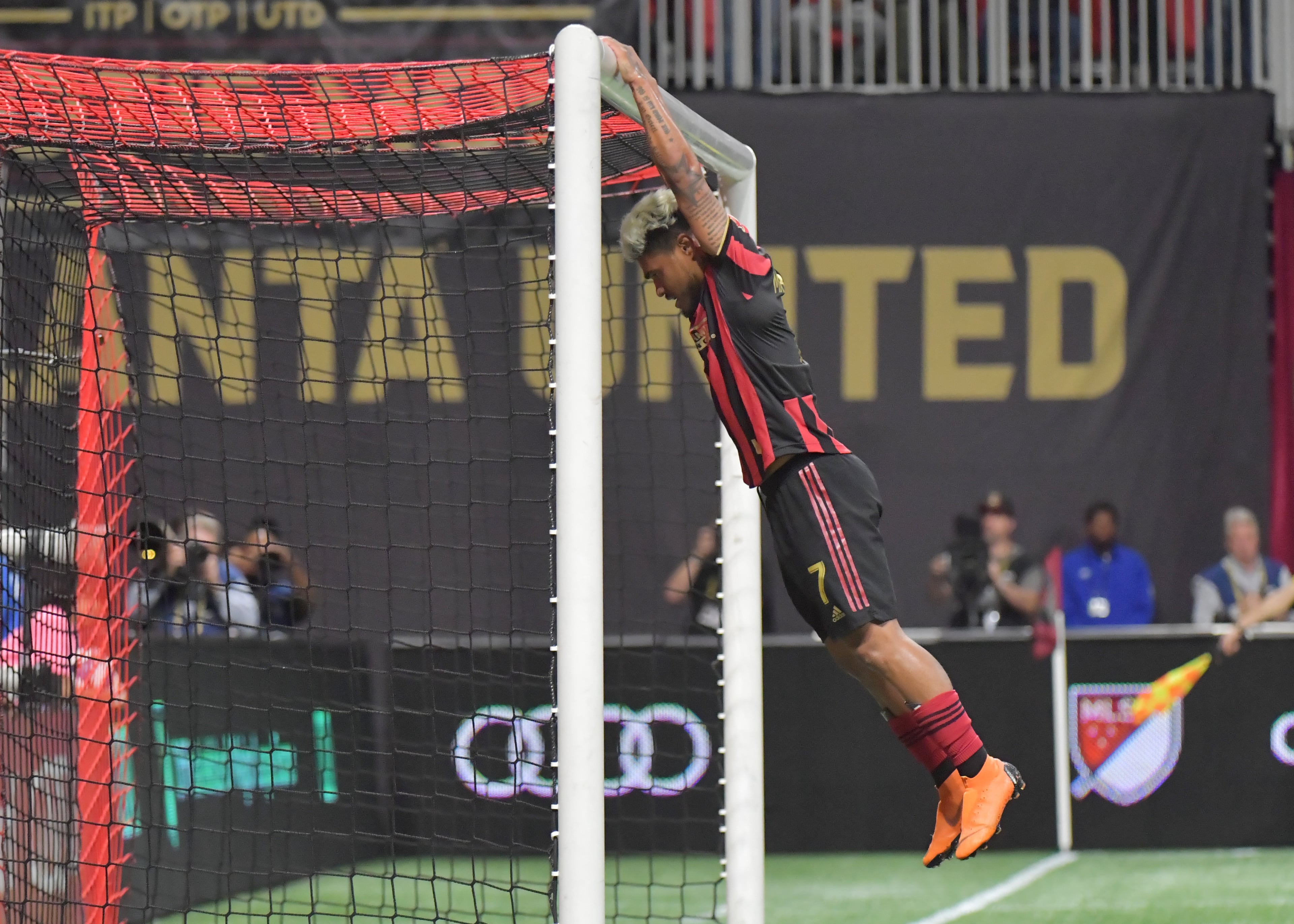 Josef Martinez hangs on the goal post after he missed a chance in 2019. (Hyosub Shin / Hyosub.Shin@ajc.com)