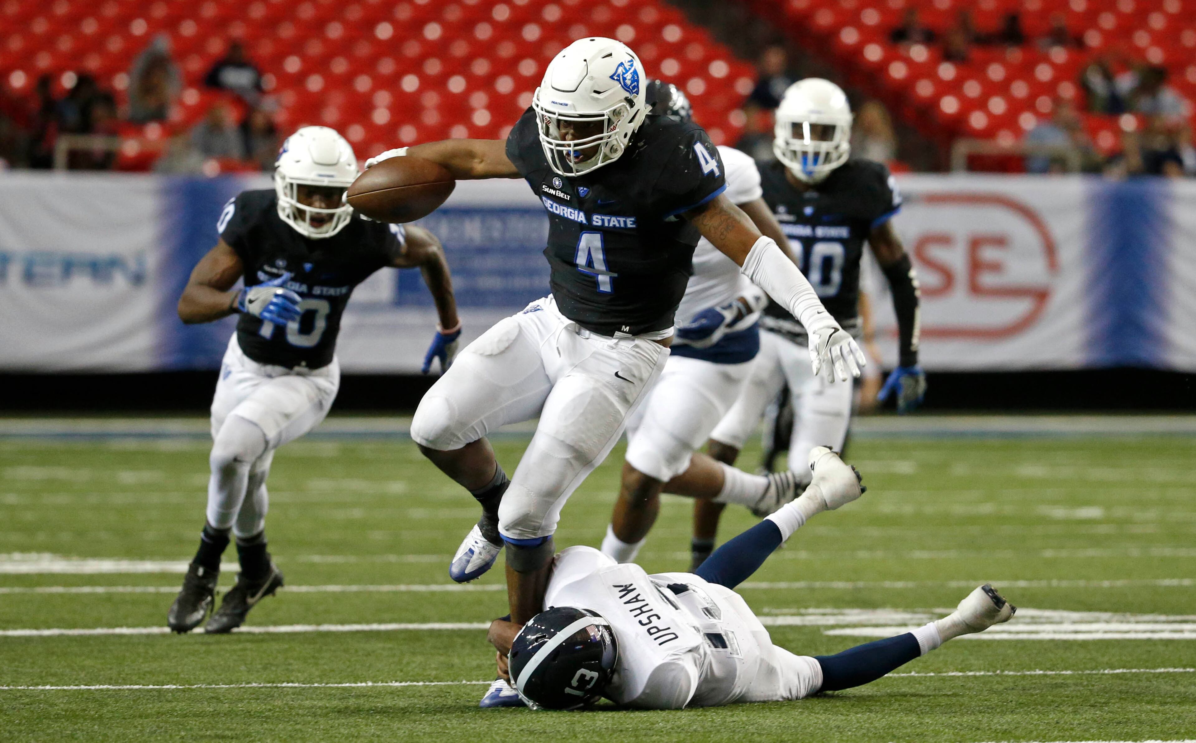November 19, 2016 - Atlanta, Ga: Georgia State Panthers linebacker Alonzo McGee (4) returns a fumble as he is tackled by Georgia Southern Eagles quarterback Favian Upshaw (13) in the second half of their game at the Georgia Dome Saturday November 19, 2016, in Atlanta, Ga. Georgia State won 30-24. PHOTO / JASON GETZ