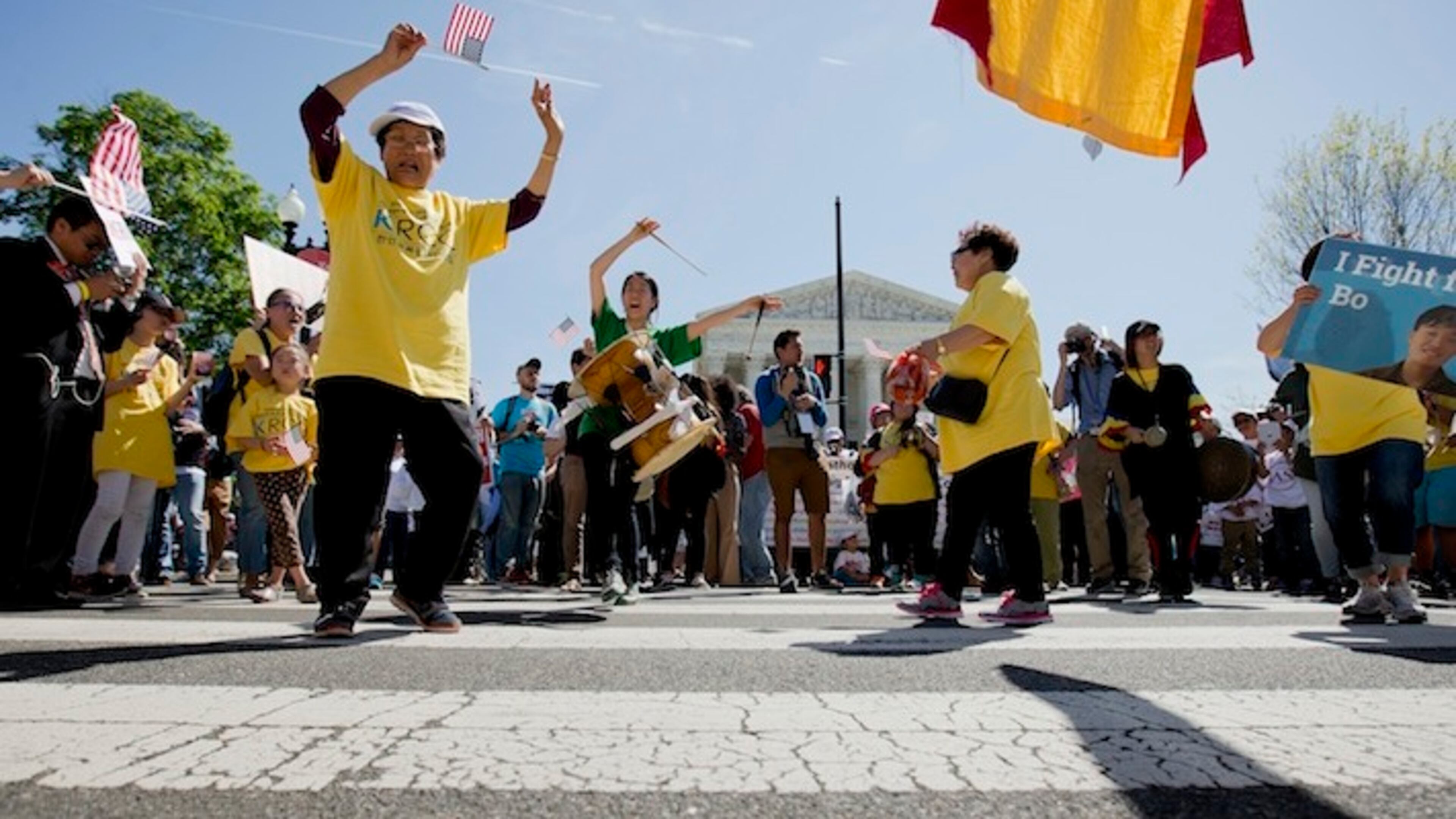 Supporters of fair immigration reform dance in front of the Supreme Court in Washington, Monday, April 18, 2016. The Supreme Court is taking up an important dispute over immigration that could affect millions of people who are living in the country illegally. The Obama administration is asking the justices in arguments today to allow it to put in place two programs that could shield roughly 4 million people from deportation and make them eligible to work in the United States. (AP Photo/Pablo Martinez Monsivais)
