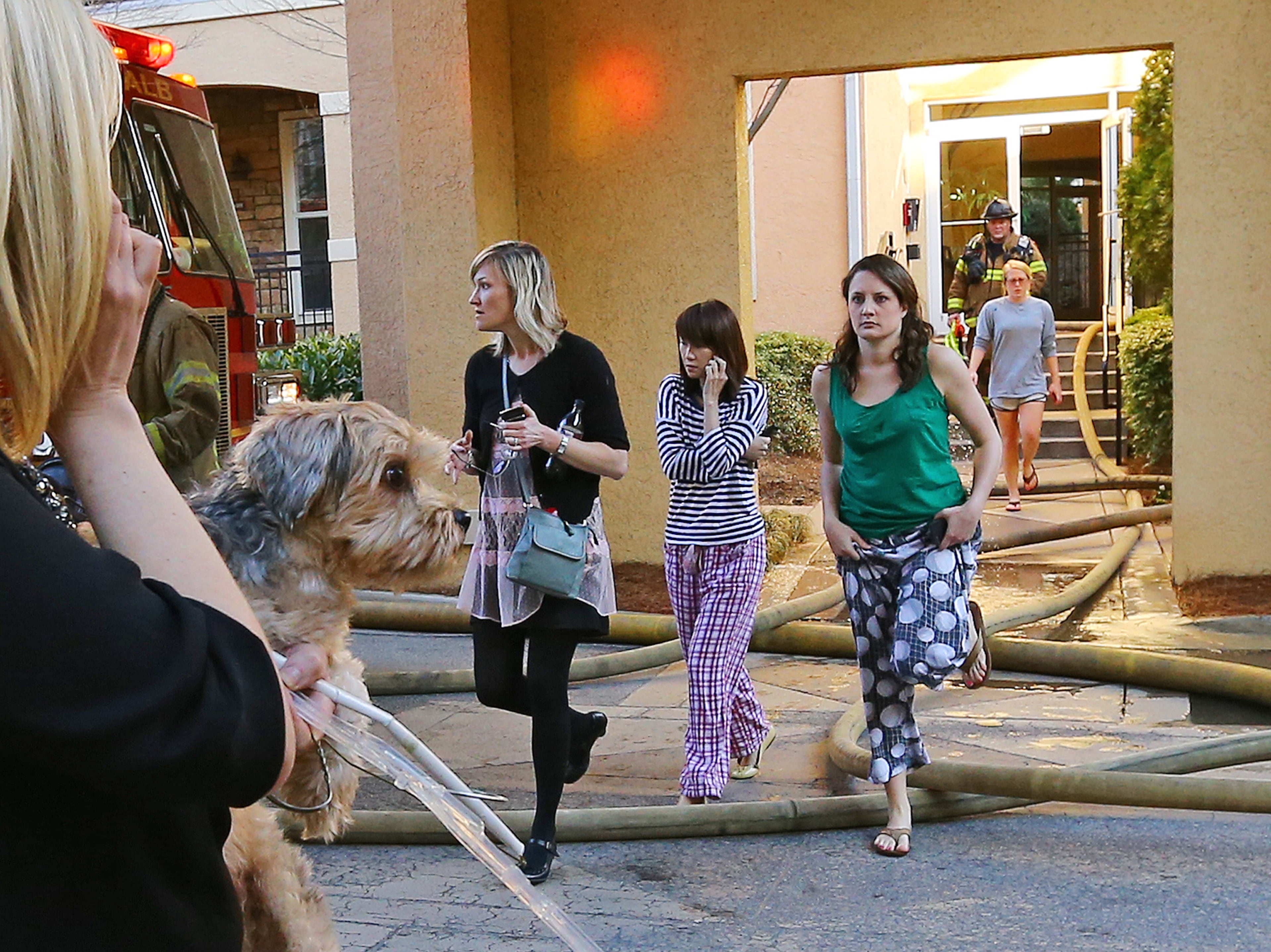 Firefighters evacuate residents from an apartment fire at Villa Sonoma Apartments on 10 Perimeter Summit Boulevard on Thursday, March 20, 2014, in Atlanta. CURTIS COMPTON / CCOMPTON@AJC.COM