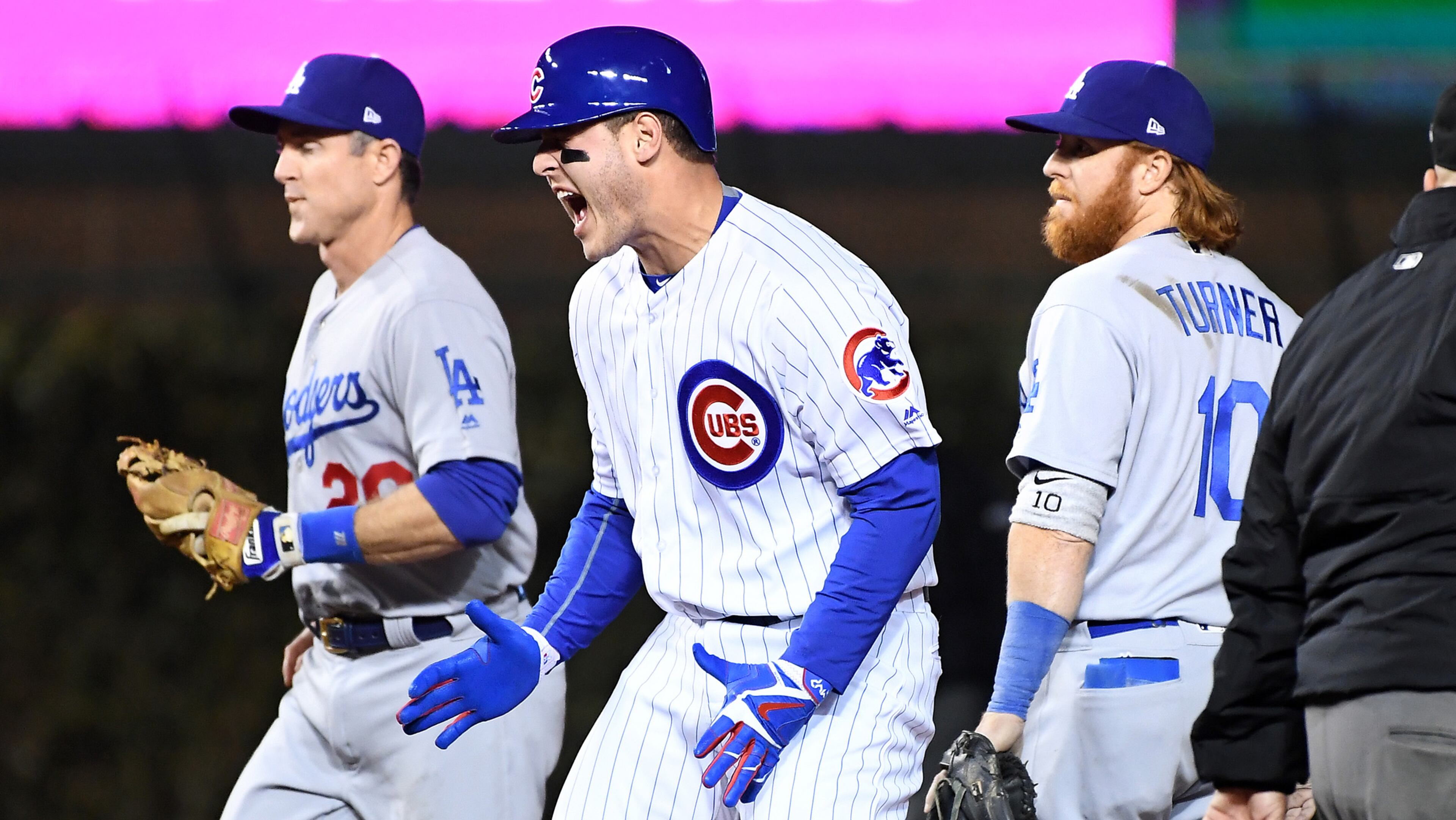 The Chicago Cubs' Anthony Rizzo reacts in front of Los Angeles Dodgers infielders Chris Utley, left, and Justin Turner after a dropped ball by outfielder Andrew Toles in the first inning during Game 6 of the National League Championship Series at Wrigley Field in Chicago on Saturday, Oct. 22, 2016. (Wally Skalij/Los Angeles Times/TNS)