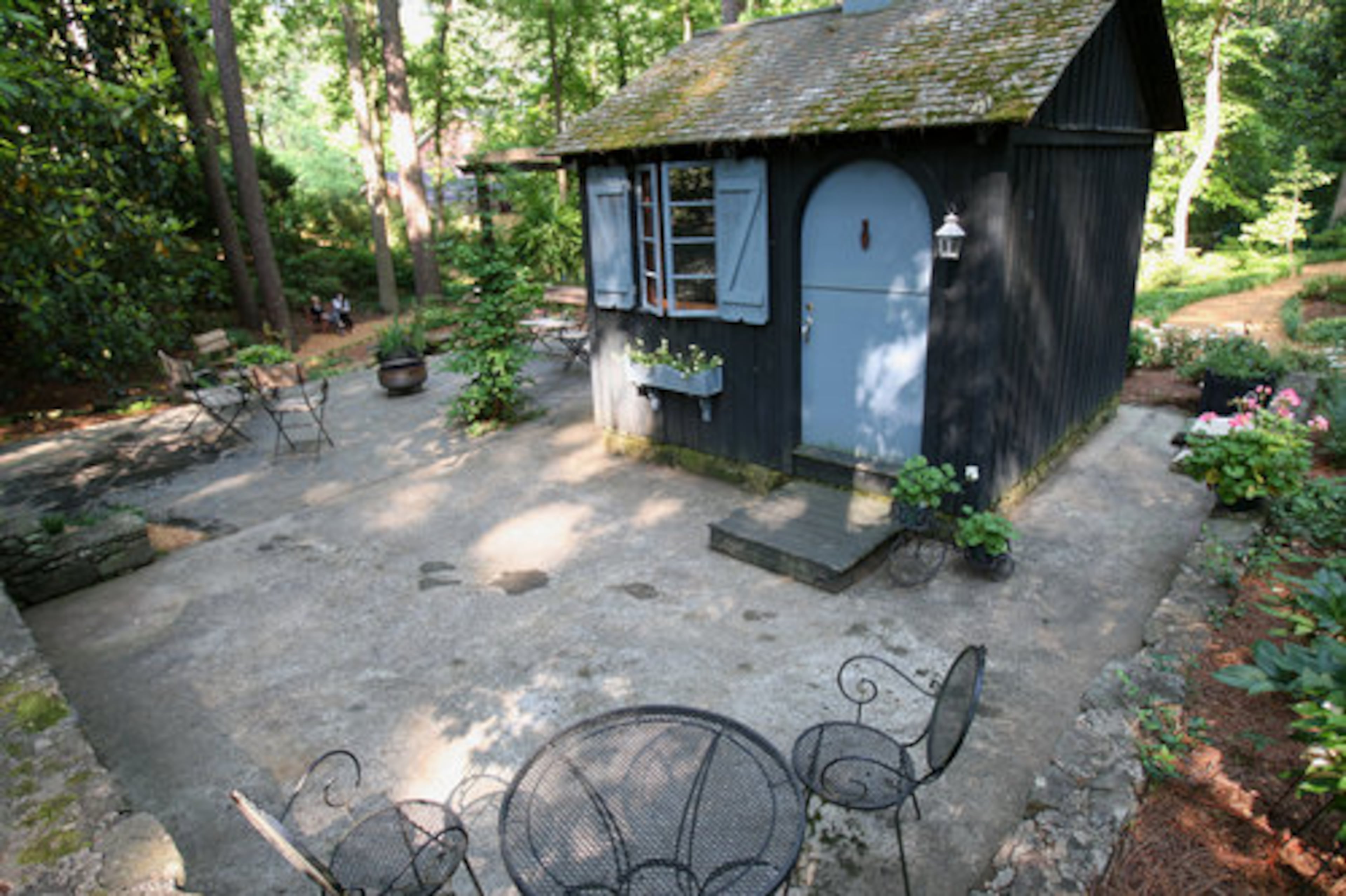 A charming garden house is surrounded by wandering trails. The vast lawn area provides room for fun or just strolling.