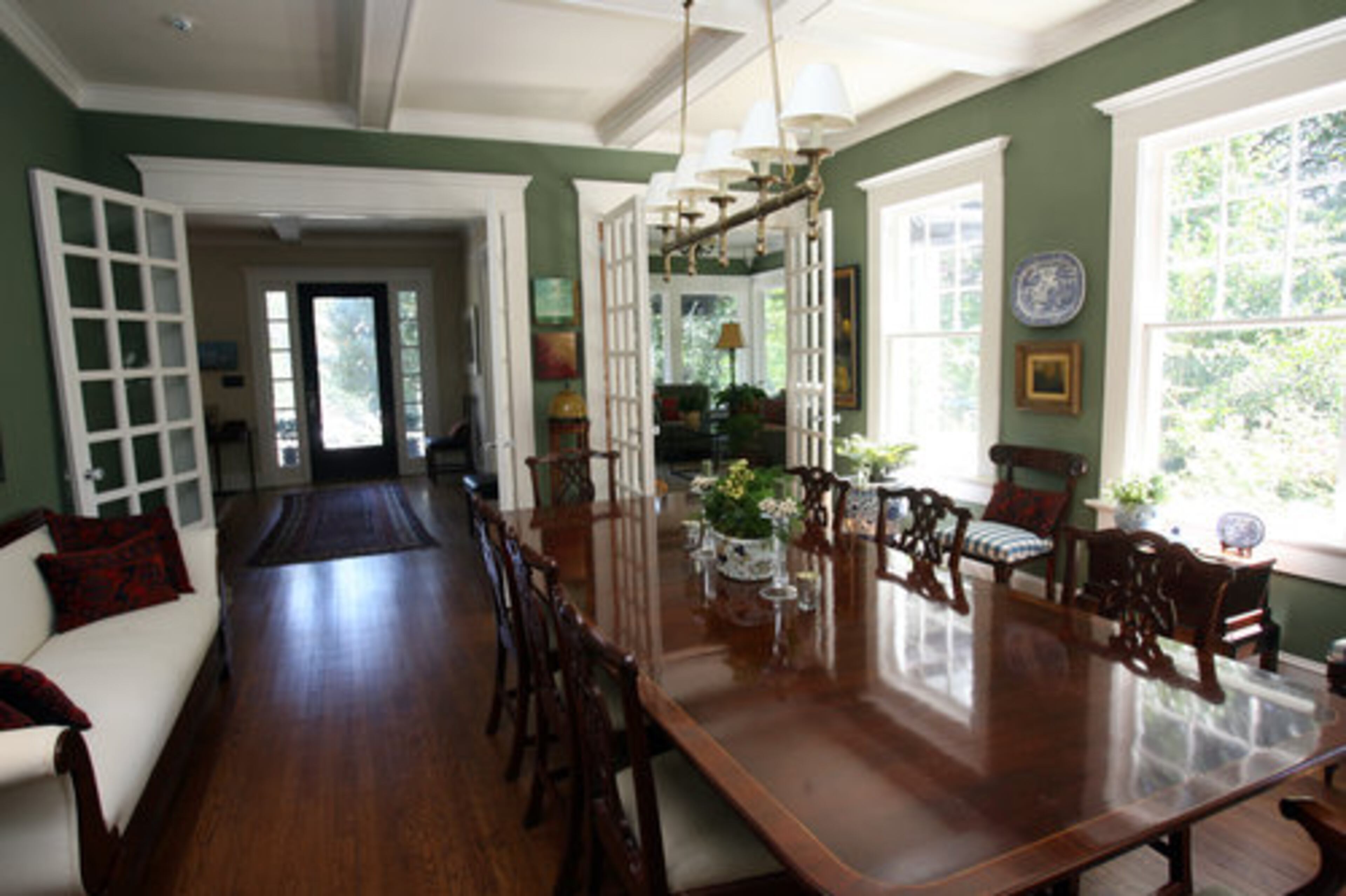 The dining room offers a large dining room table and an expansive entryway.