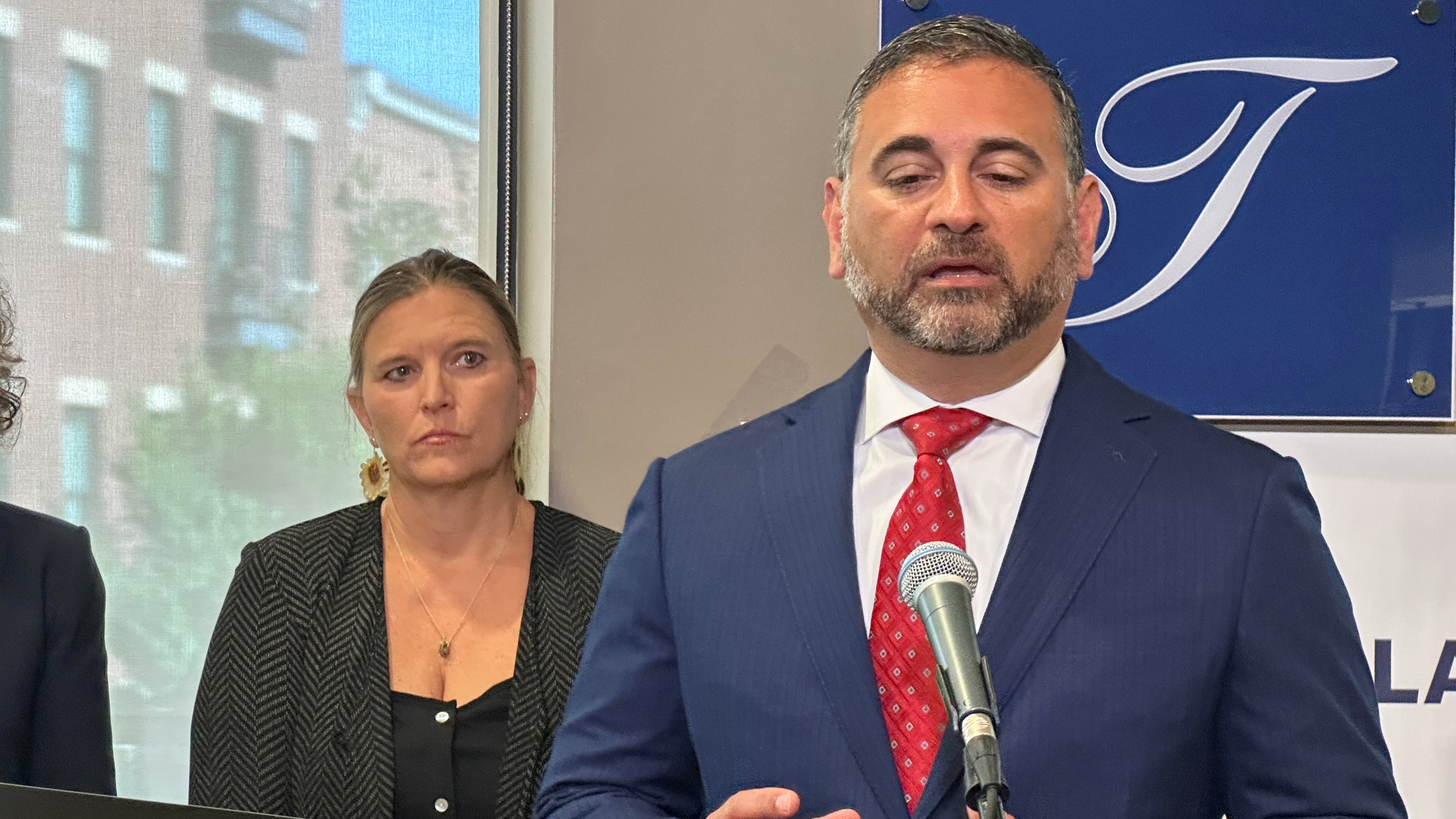 Tad Thomas, a lawyer for the family of Henry Willis, right, speaks at a news conference while Willis' mother, Laura Herp, looks on Thursday, July 16, 2026, in Louisville, Ky. (AP Photo/Dylan Lovan)
