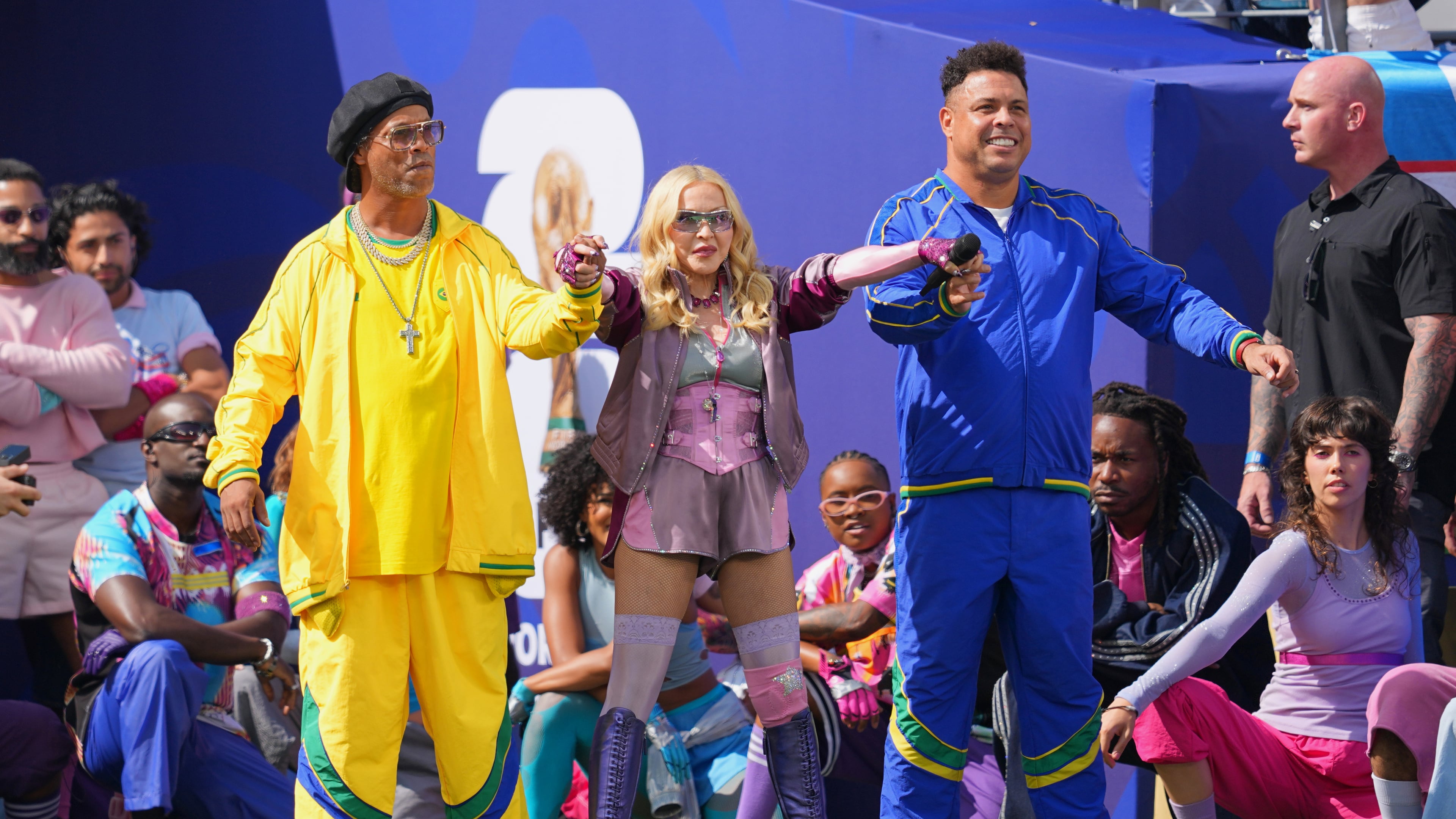 Ronaldinho, left, and Ronaldo stand with Madonna as she performs during the halftime show in the World Cup final soccer match between Spain and Argentina in East Rutherford, N.J., near New York, Sunday, July 19, 2026. (AP Photo/Julio Cortez)
