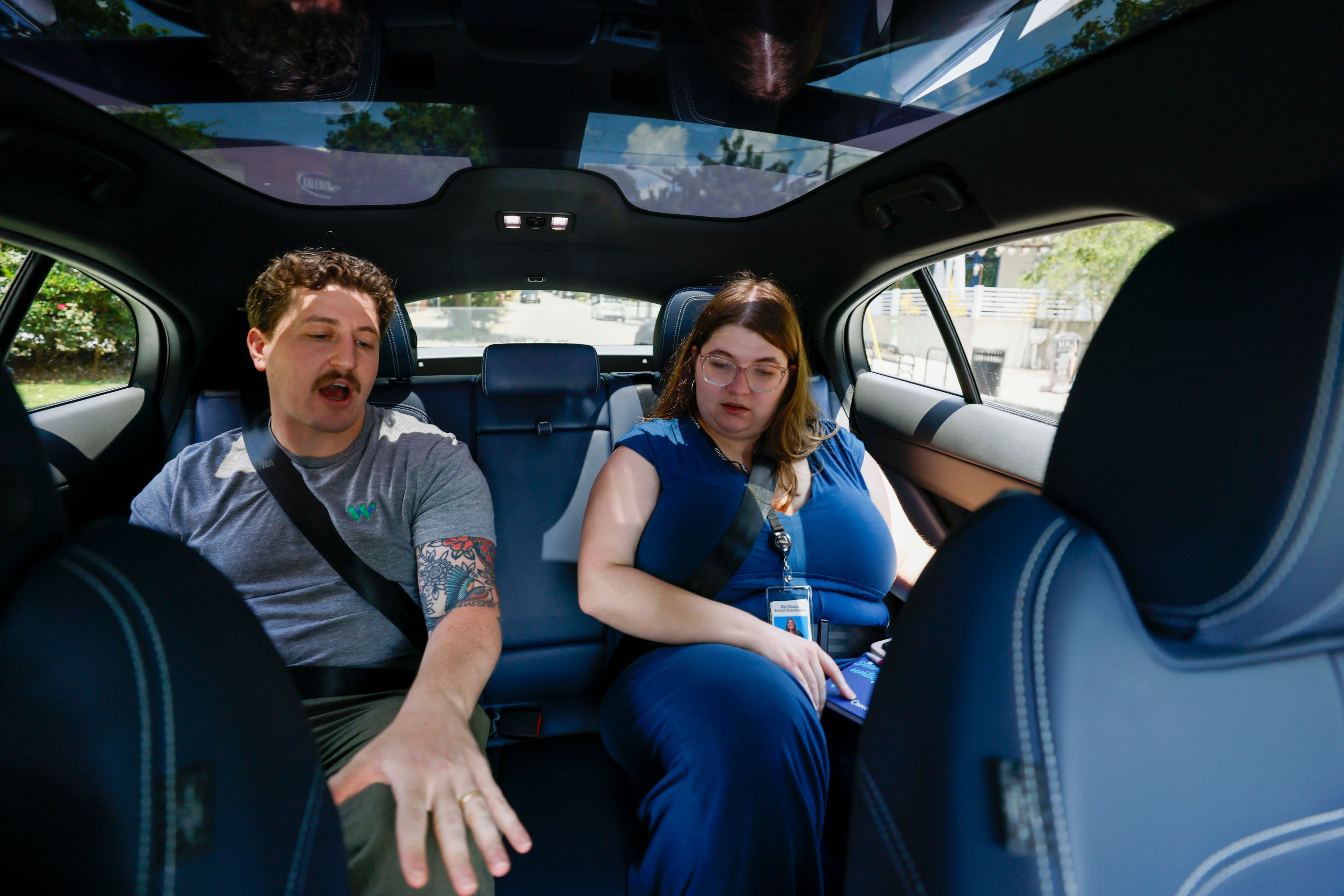 Ethan Teicher, a spokesman for Waymo, explained many features of the Waymo self-driving vehicle to an AJC intern reporter, Allison Mawn, during a test drive on Monday, June 23, 2025.
(Miguel Martinez/ AJC)