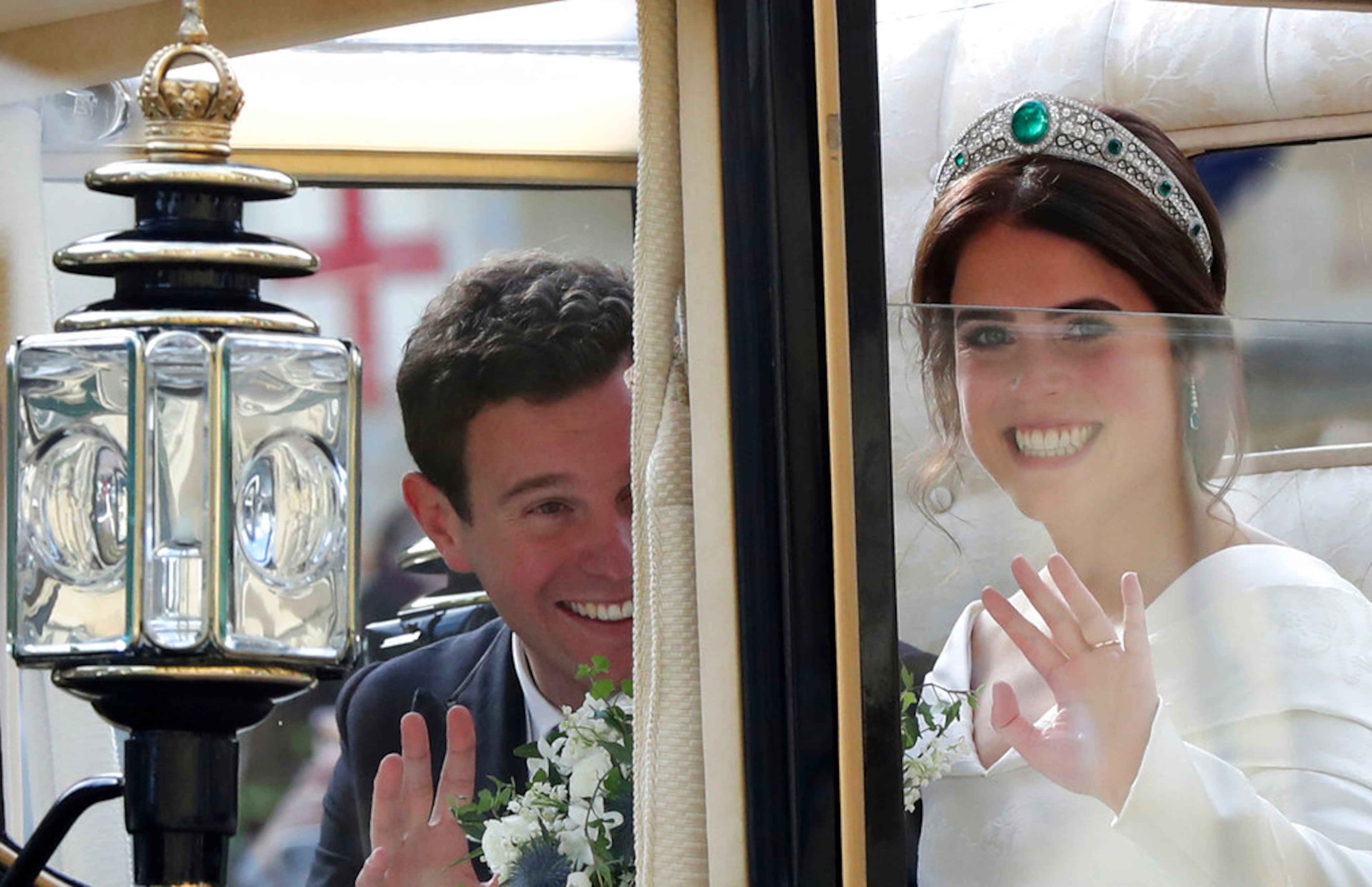 Britain's Princess Eugenie of York, right, and her husband Jack Brooksbank travel in the Scottish State Coach following their wedding at St Georgeâs Chapel, Windsor Castle, near London, England, Friday Oct. 12, 2018. (Gareth Fuller/Pool via AP)