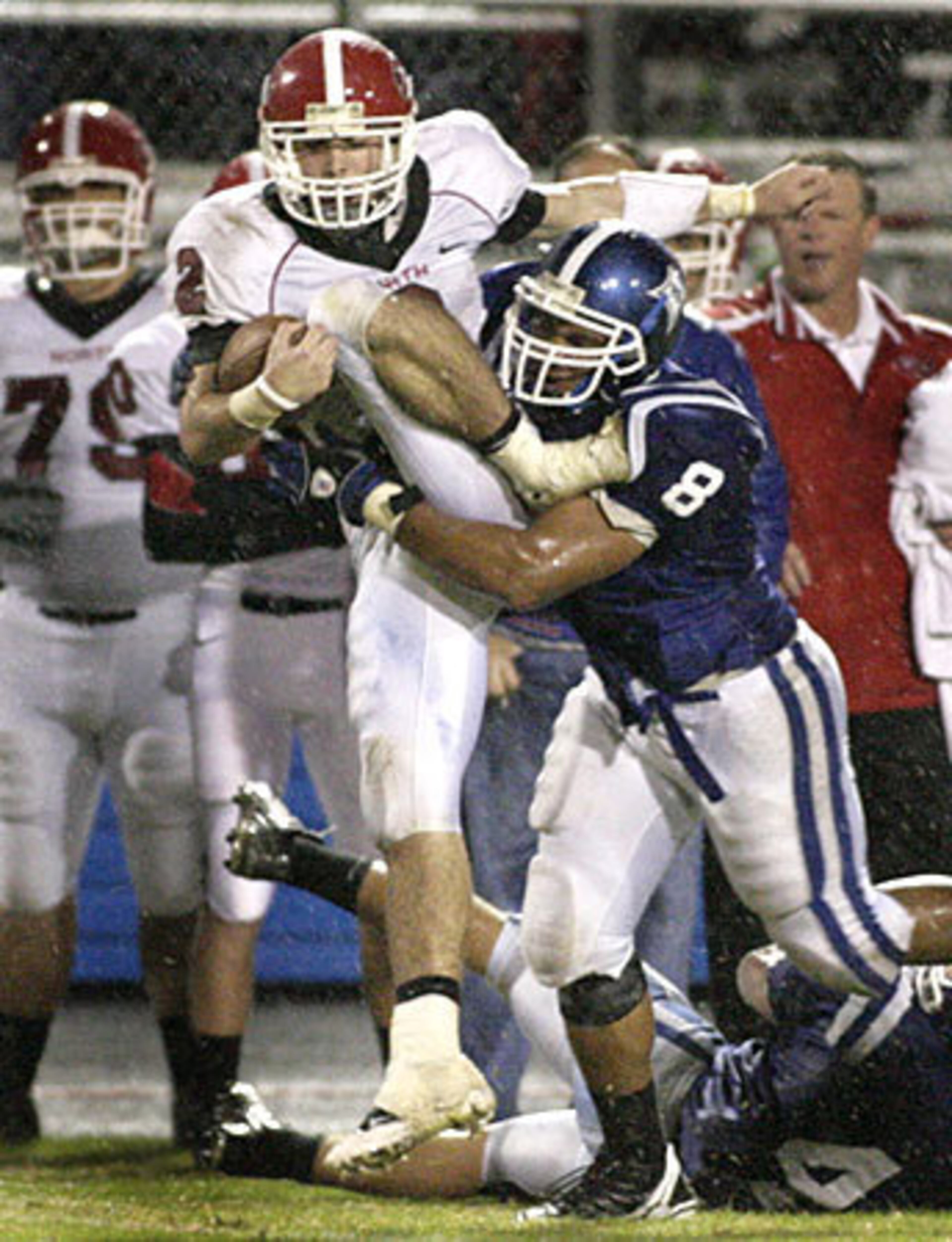 North Gwinnett quarterback Michael Tamburo (9) makes yards while Peachtree Ridge DT Reggie Turner (73) pursues.