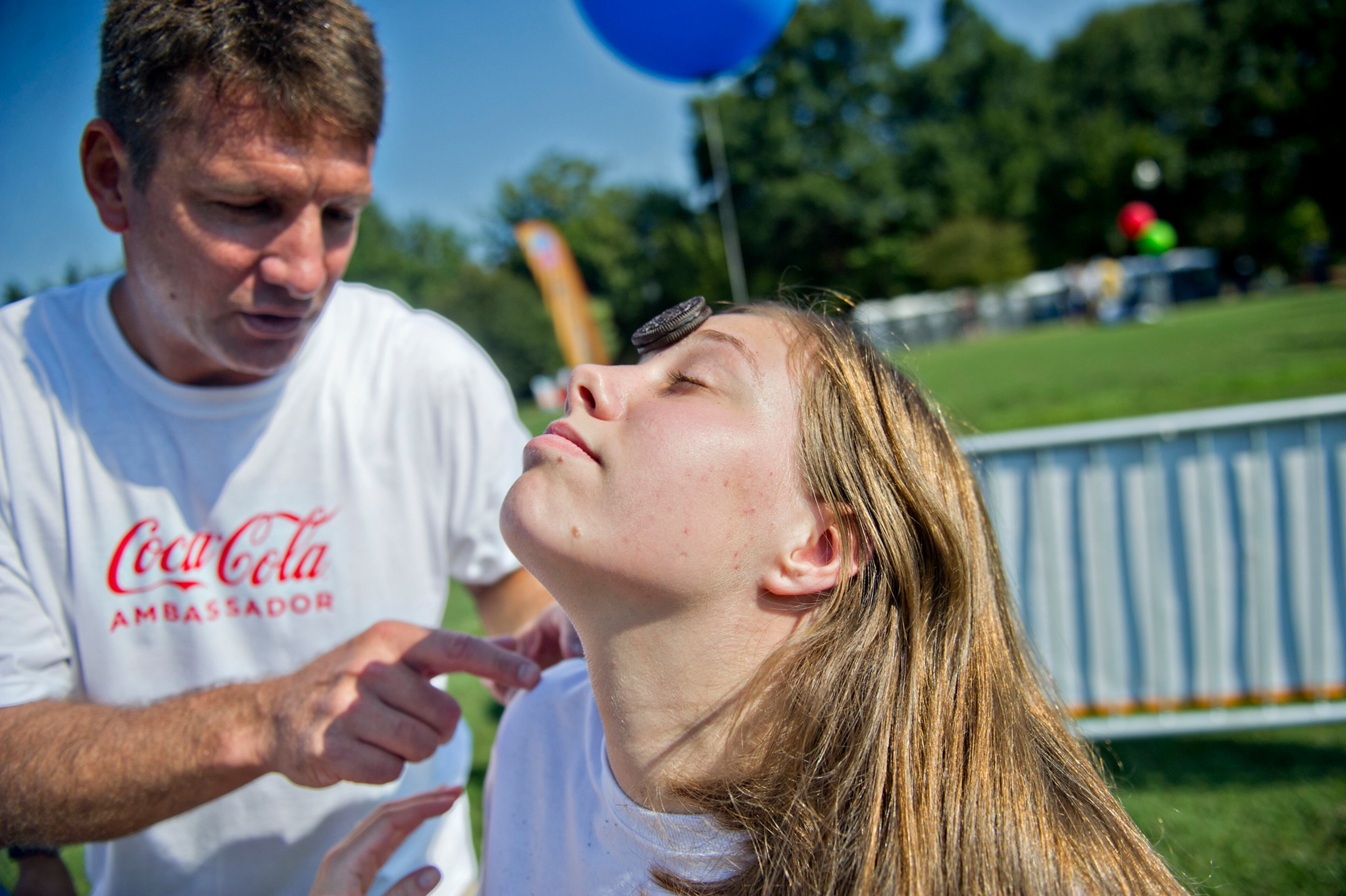 Stacey Oglesby (right) balances an oreo cookie on her forehead as Vic Stephens gives advice on how to get it to her mouth without using her hands during the Boys & Girls Clubs of America's Day for Kids at Piedmont Park in Atlanta on Saturday, September 7, 2013. Day for Kids is a national initiative to raise awareness for critical issues facing young men and women. With more than a decade of tradition, Day for Kids invites adults to act like kids again by participating in field day events such as relay races, dodge ball, tug of war and lots of other activities. JONATHAN PHILLIPS / SPECIAL