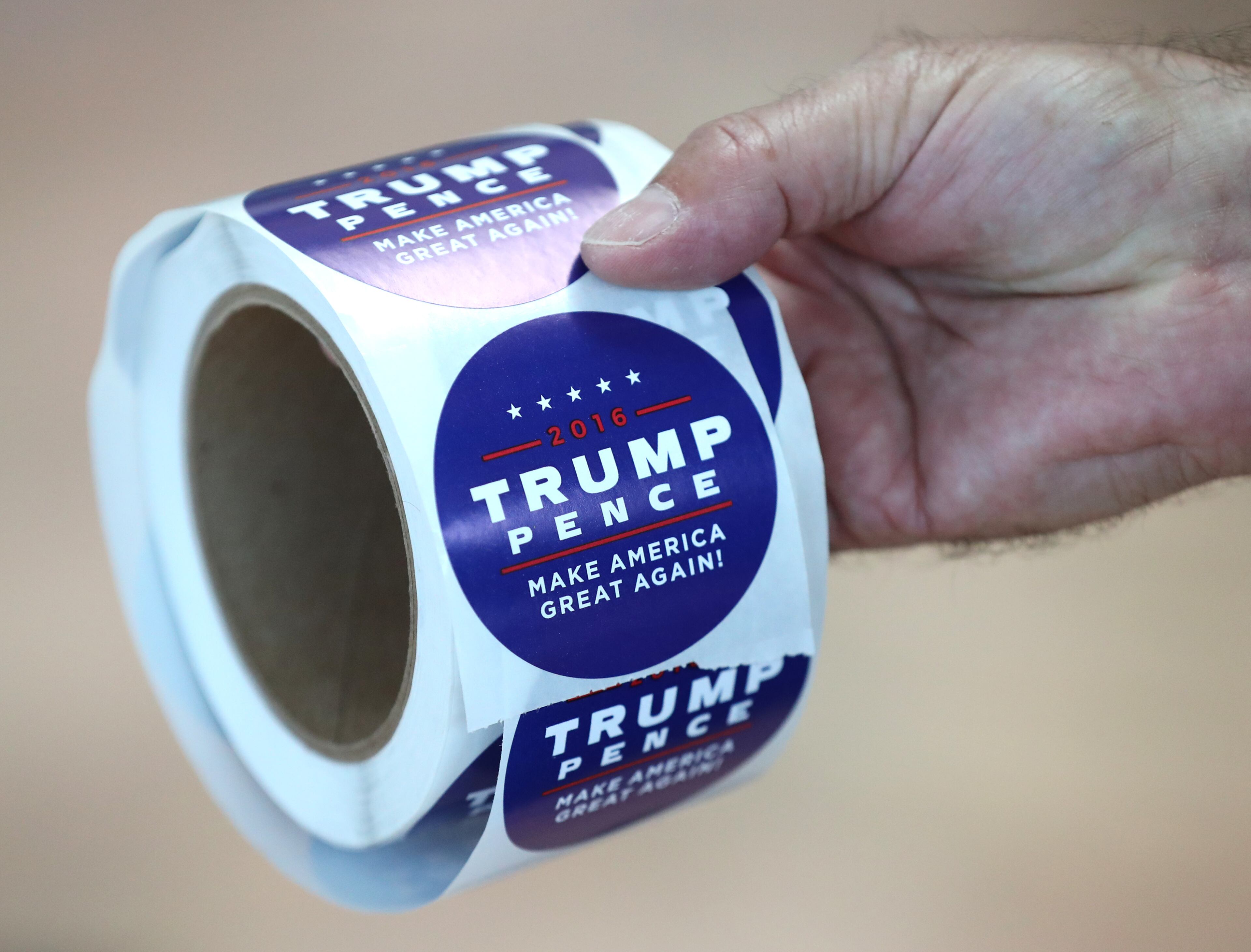 Michael Amaral hands out Trump-Spence stickers during Republican Vice Presidential nominee Mike Pence's campaign stop on Monday, August 29, 2016, in Marietta. Curtis Compton /ccompton@ajc.com