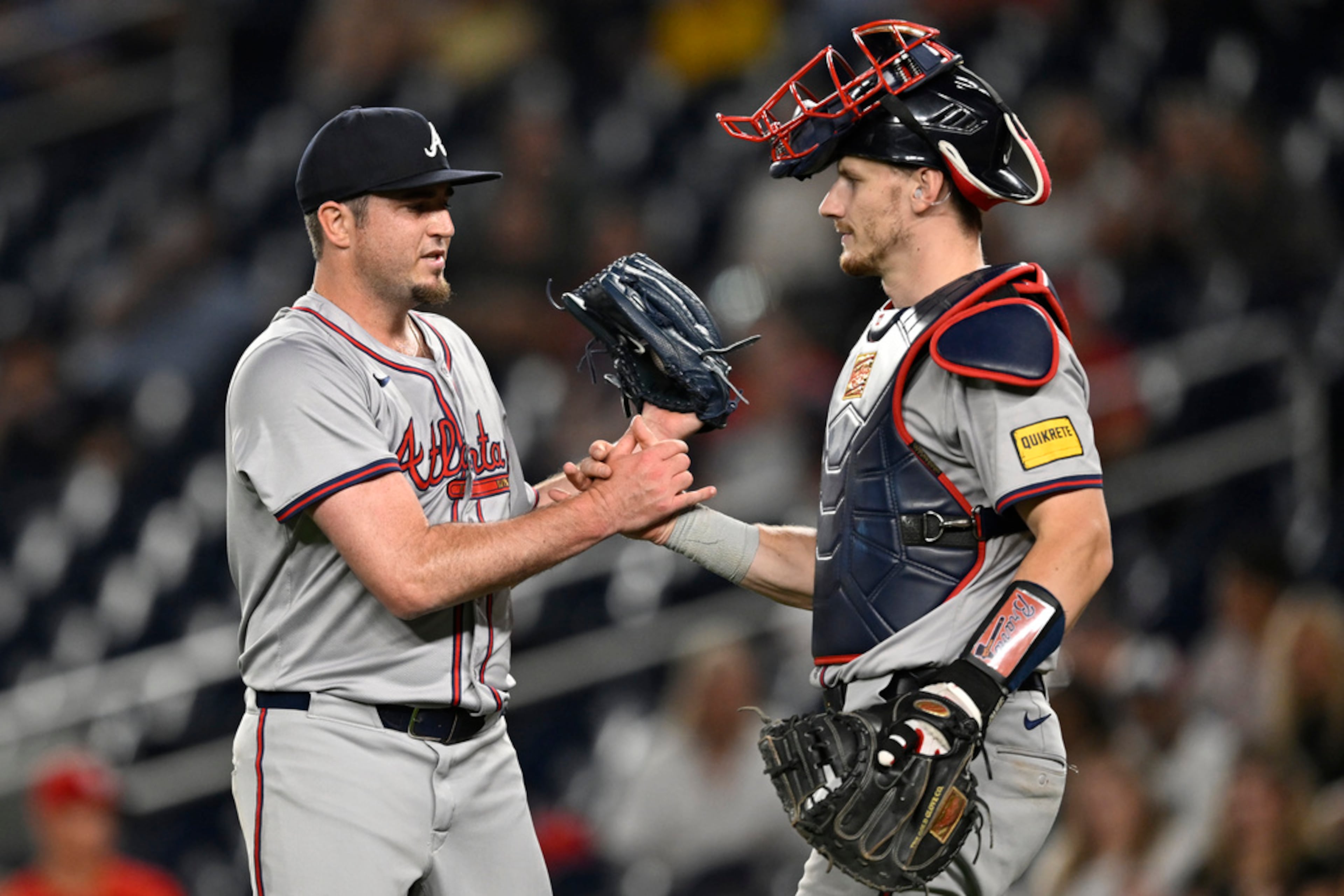 Braves relief pitcher Luke Jackson, left, is congratulated by catcher Sean Murphy after finishing off the ninth inning to defeat the Washington Nationals in a baseball game, Tuesday, Sept. 10, 2024, in Washington. The Braves won 12-0. (AP Photo/John McDonnell)
