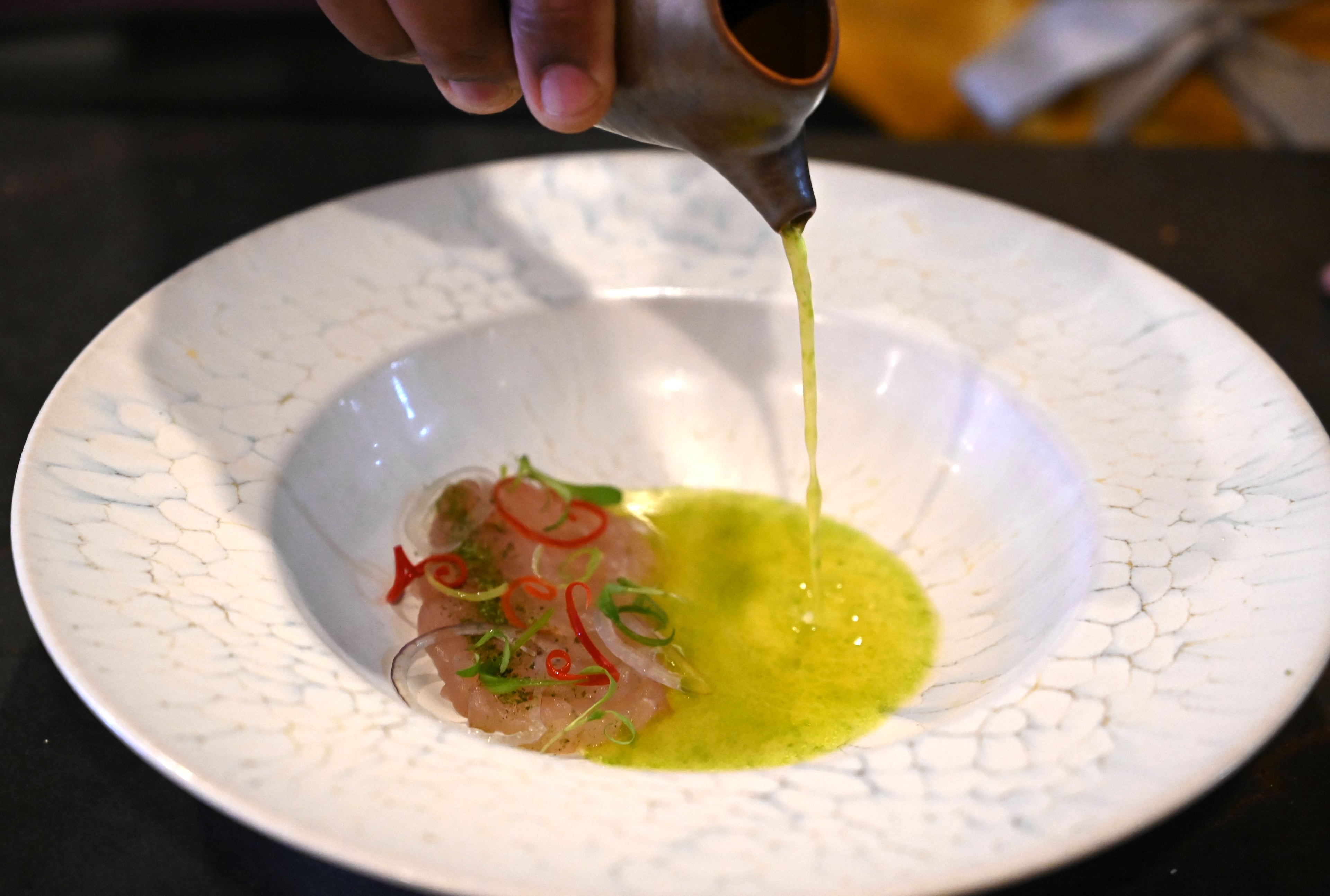 Chef Demetrius Brown prepares Crudo from Haiti at Heritage Supper Club on Friday, Sept. 4, 2026, in Atlanta. Heritage, Brown’s highly anticipated new restaurant, is set to open Sept. 10. (Hyosub Shin/AJC)
