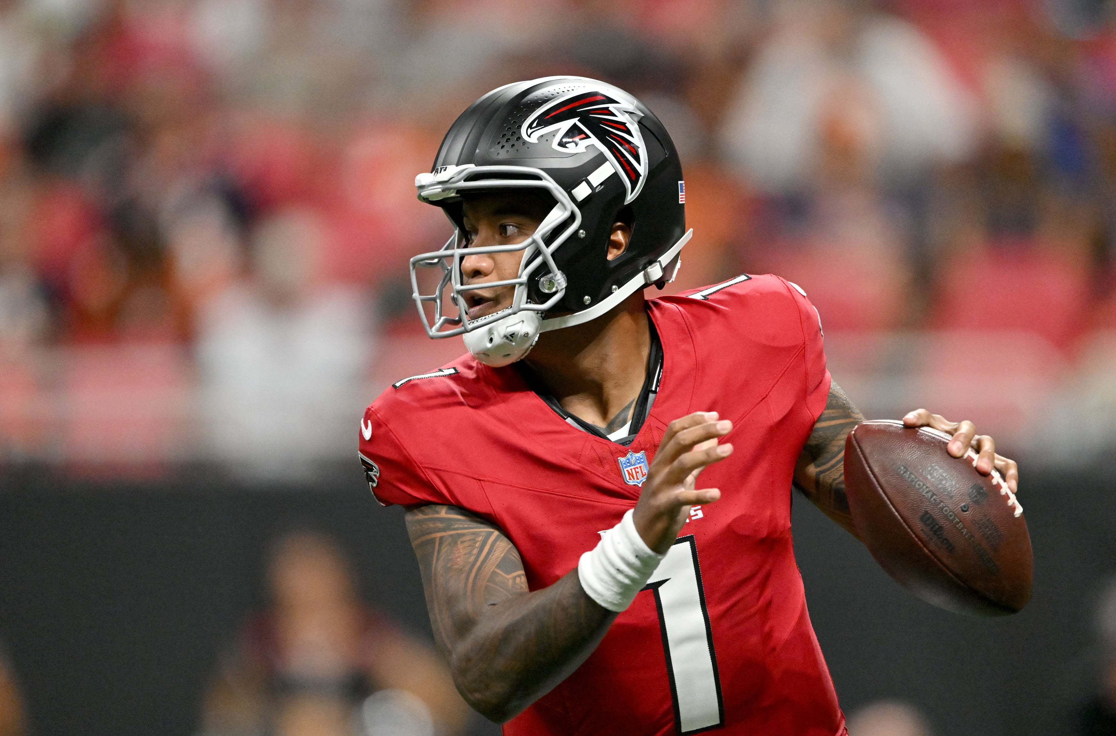 Falcons quarterback Tua Tagovailoa prepares to get off a pass during their preseason game against the Denver Broncos at Mercedes-Benz Stadium on Friday, Aug. 14, 2026, in Atlanta. (Hyosub Shin/AJC)