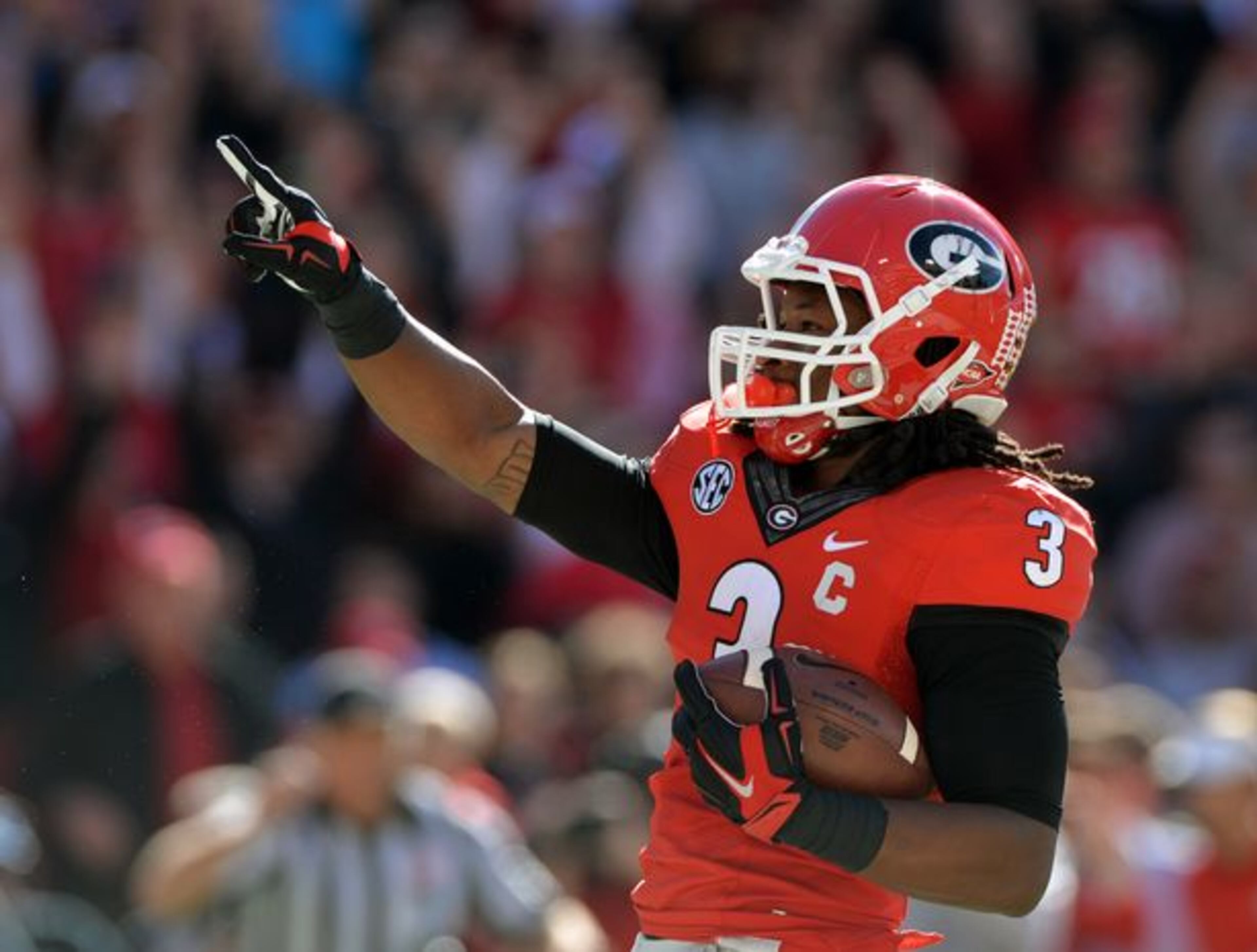 He runs! He throws! He points after scoring points! (Brant Sanderlin/AJC)