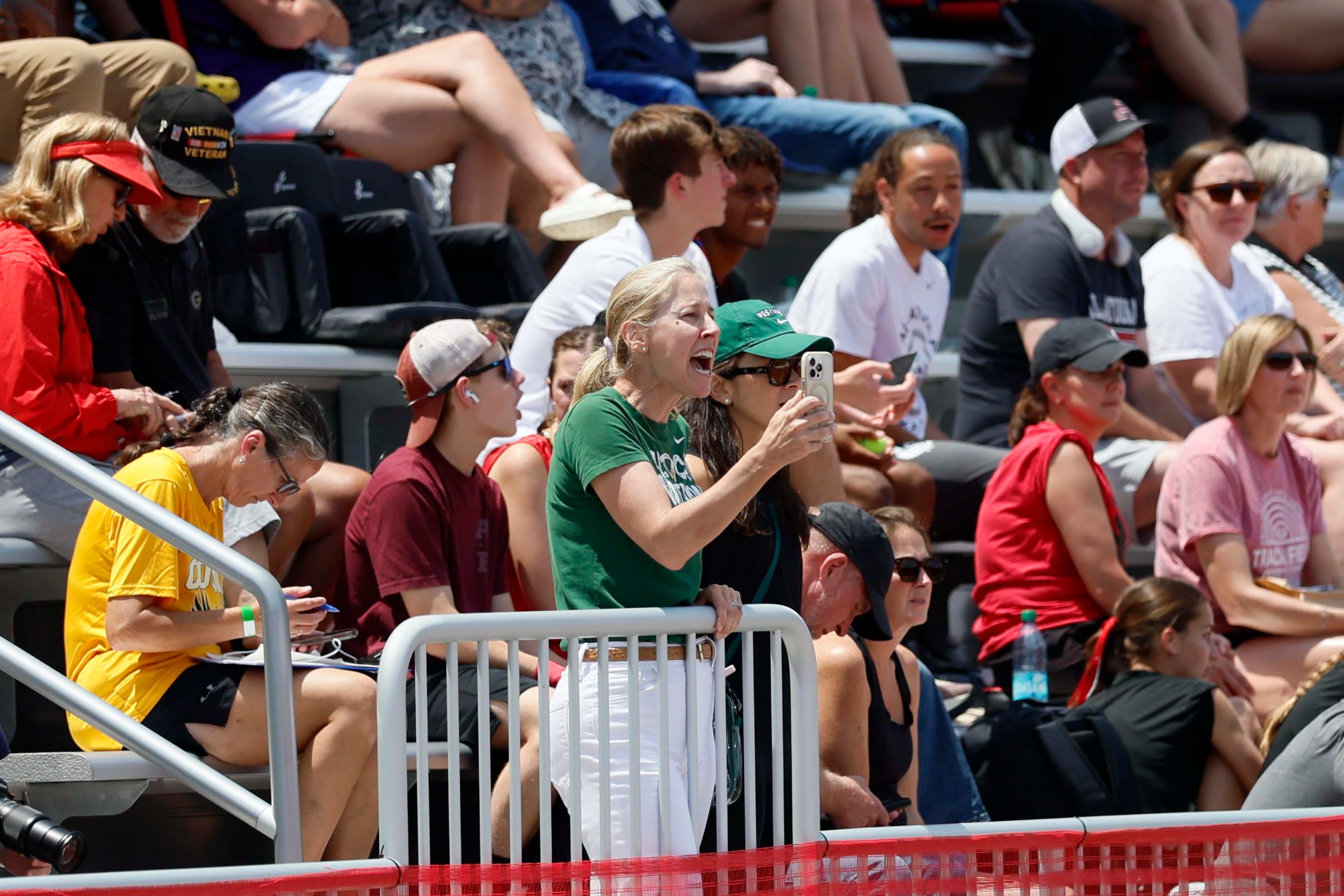 A woman cheers in the stands as runners participate in the GHSA track and field state championship at UGA's Spec Towns Track on Monday, May 11, 2026, in Athens.
(Miguel Martinez/AJC)