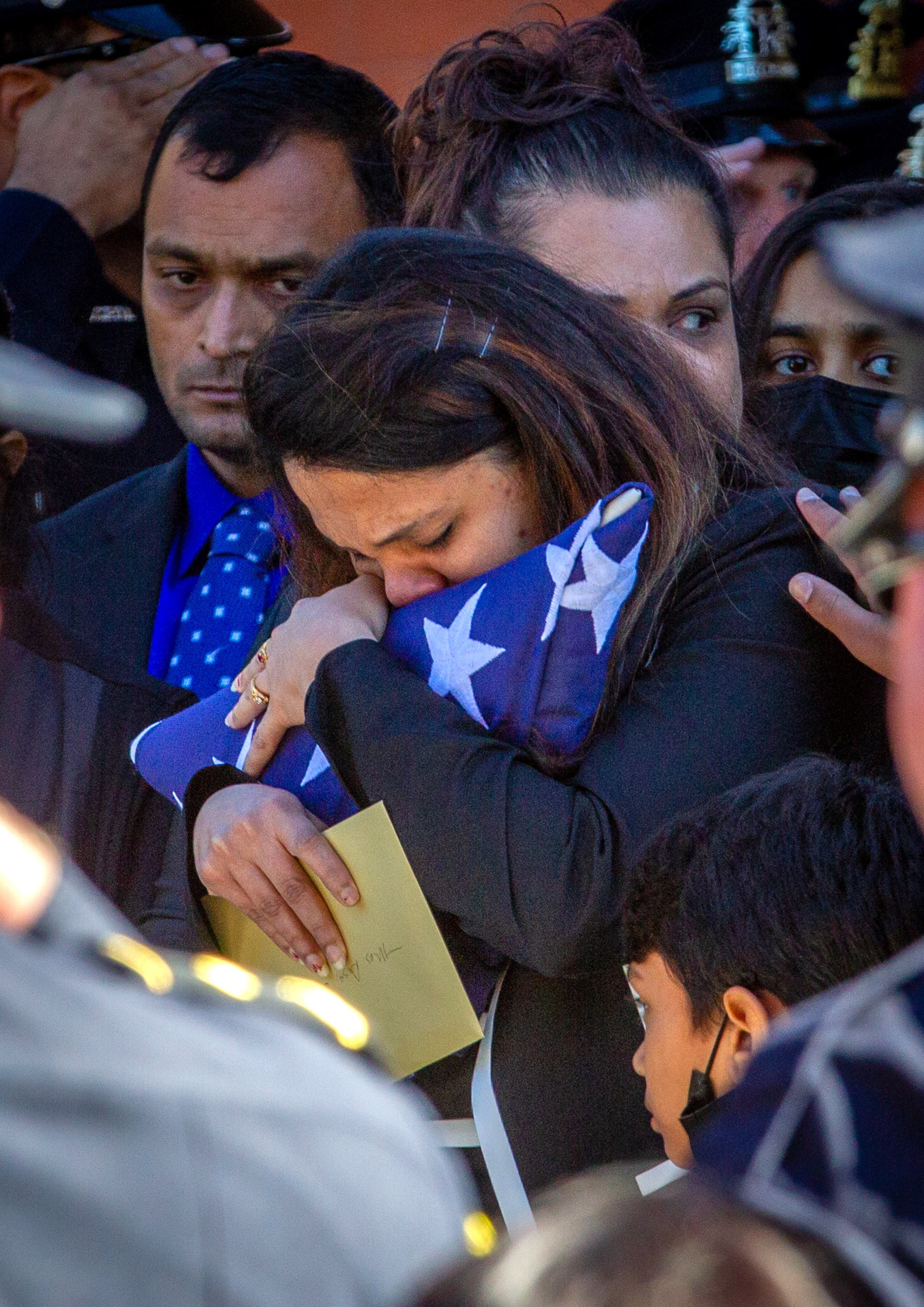 Ankita Desai, the wife of slain Henry County police Officer Paramhans Desai, holds the flag at the funeral service on Sunday, November 14, 2021, at the Henry County Performing Arts Center. (Photo: Steve Schaefer for The Atlanta Journal-Constitution)