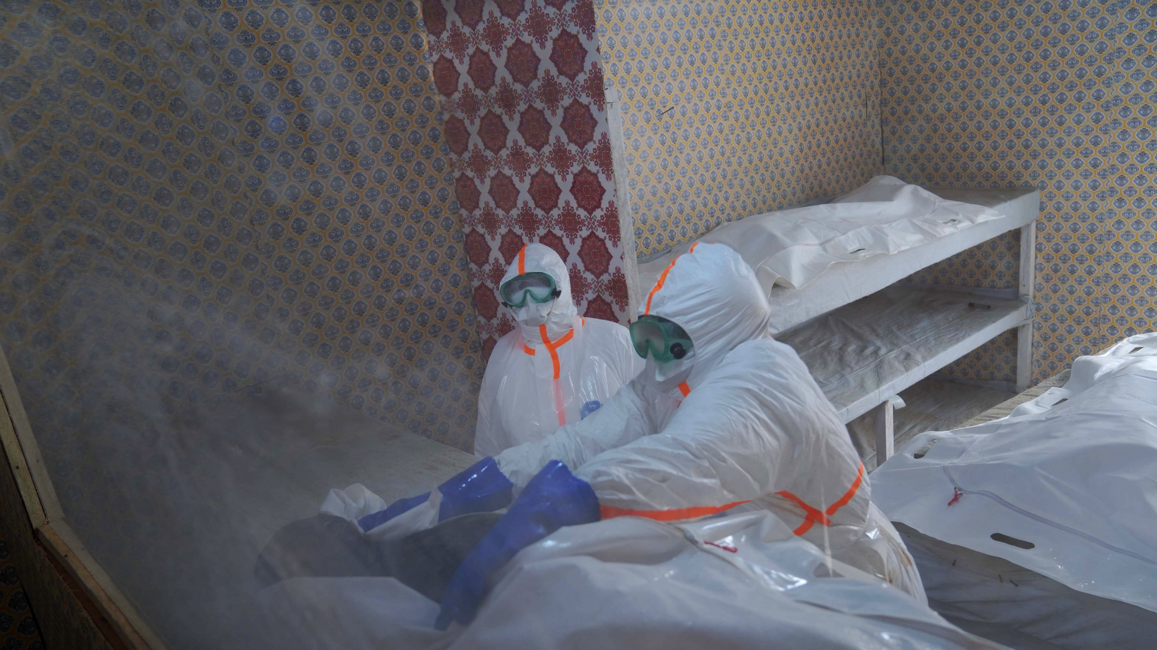 Health workers prepare to transfer the body of Abineno Justine, a 38-year-old woman who died of the Ebola virus, to a coffin ahead of her burial in Bunia, Congo, Friday, Sept. 4, 2026. (AP Photo/Dieudonne Dirole)