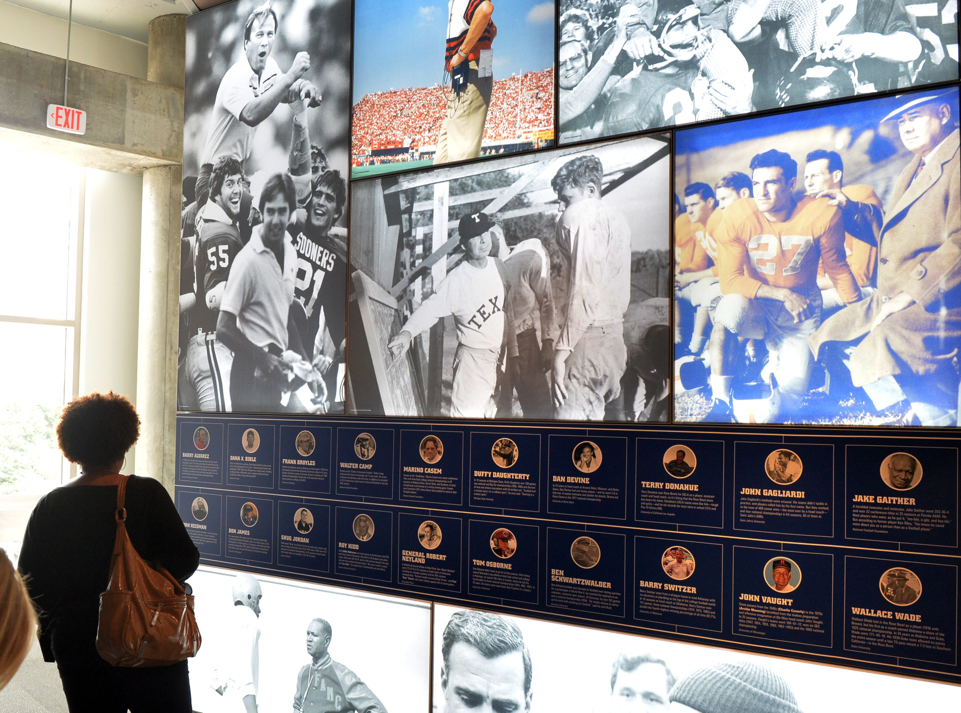 Attendees look at exhibits in the Kia Building a Champion gallery at a press conference and media day at the College Football Hall of Fame Wednesday, August 20, 2014.