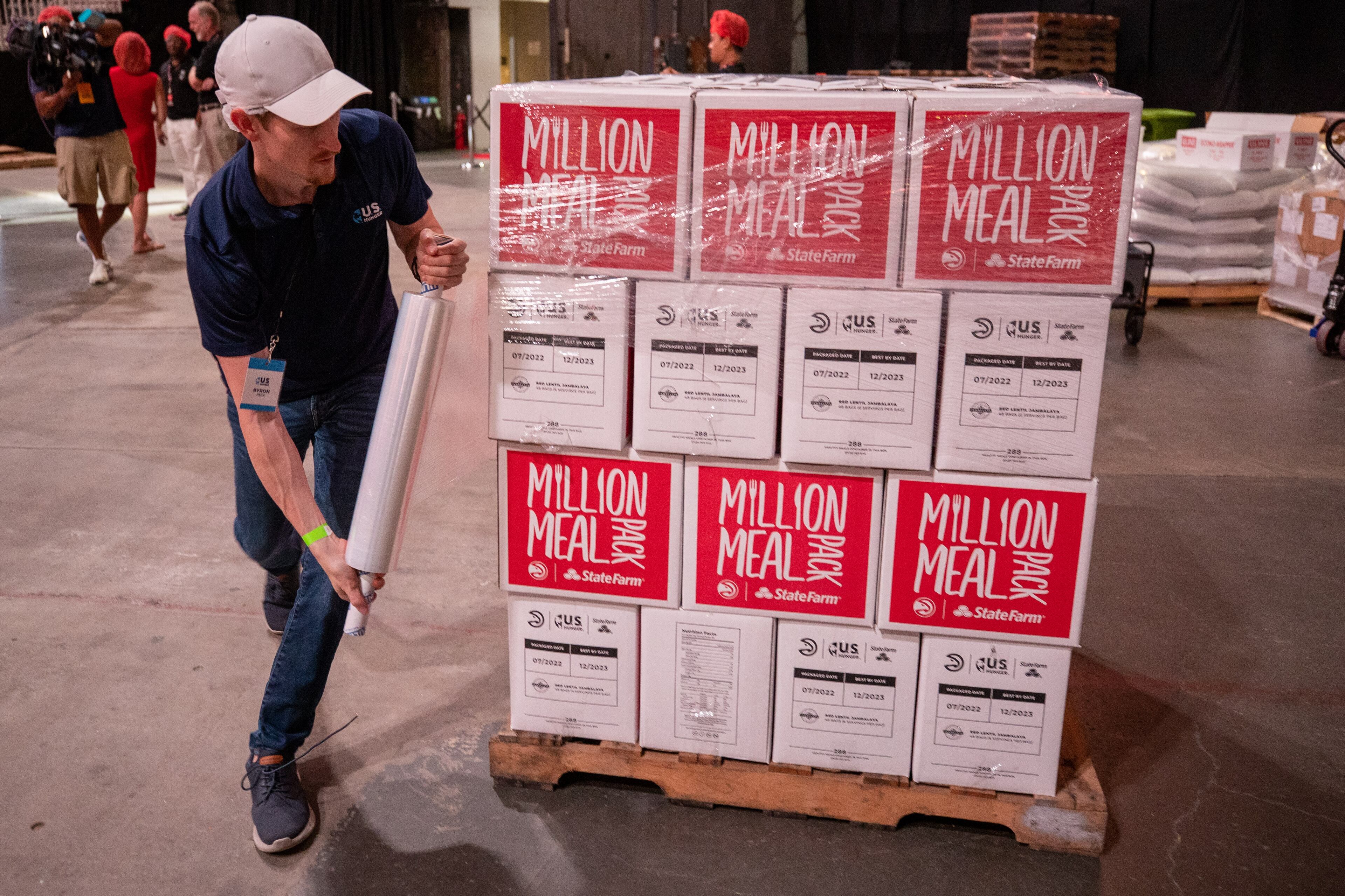 Byron Peck prepares a pallet of 44 boxes that holds 288 meals during the Million Meal Pack event on Saturday, July 16, 2022, at State Farm Arena in Atlanta. The event, which was started in 2019, is the Hawks’ largest single-day service initiative. (Photo: Steve Schaefer / steve.schaefer@ajc.com)