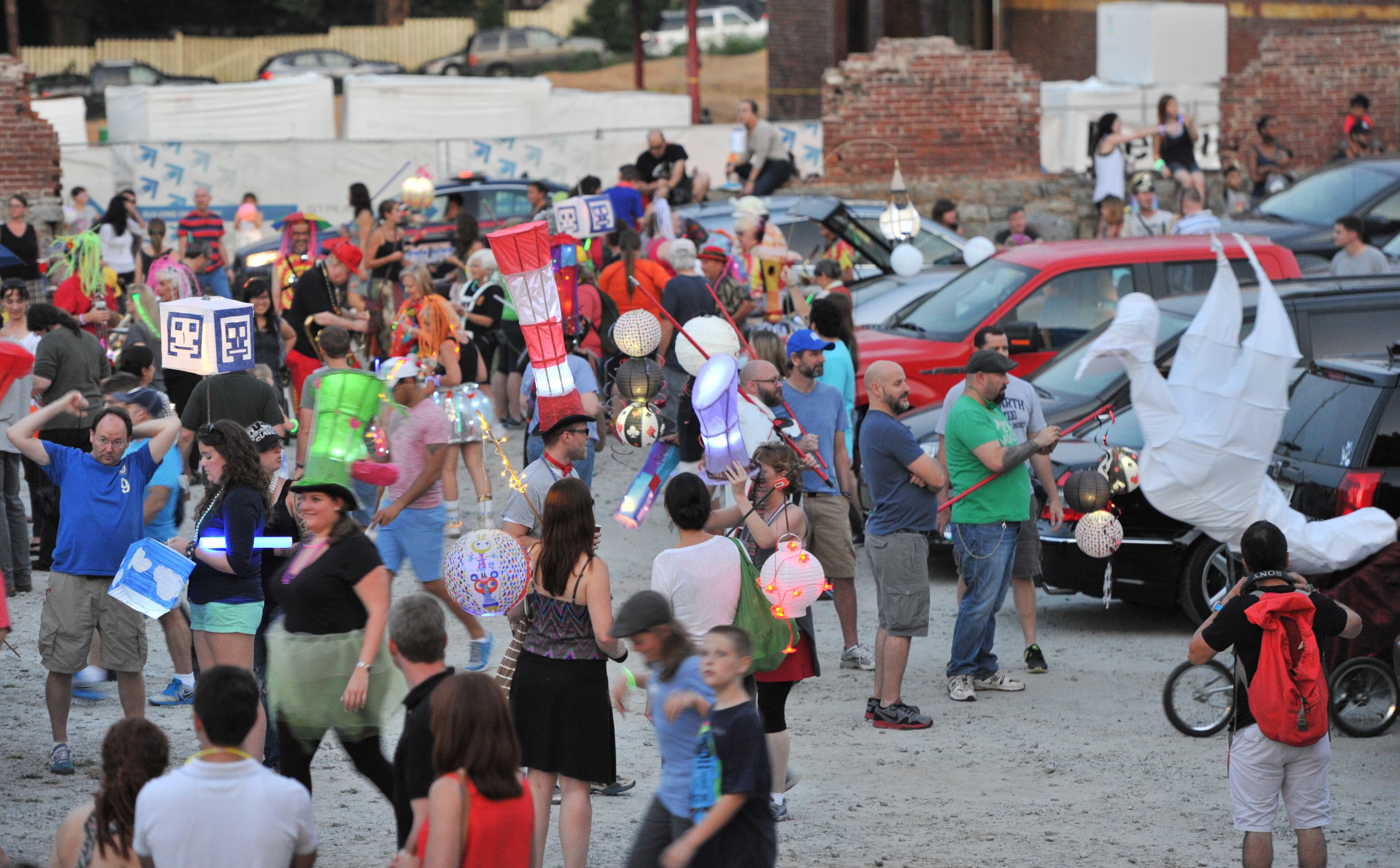Parade participants mingle during a tailgate line-up at Irwin Street and Krog Street before the 2013 Atlanta BeltLine Lantern Parade on Sept. 7, 2013.