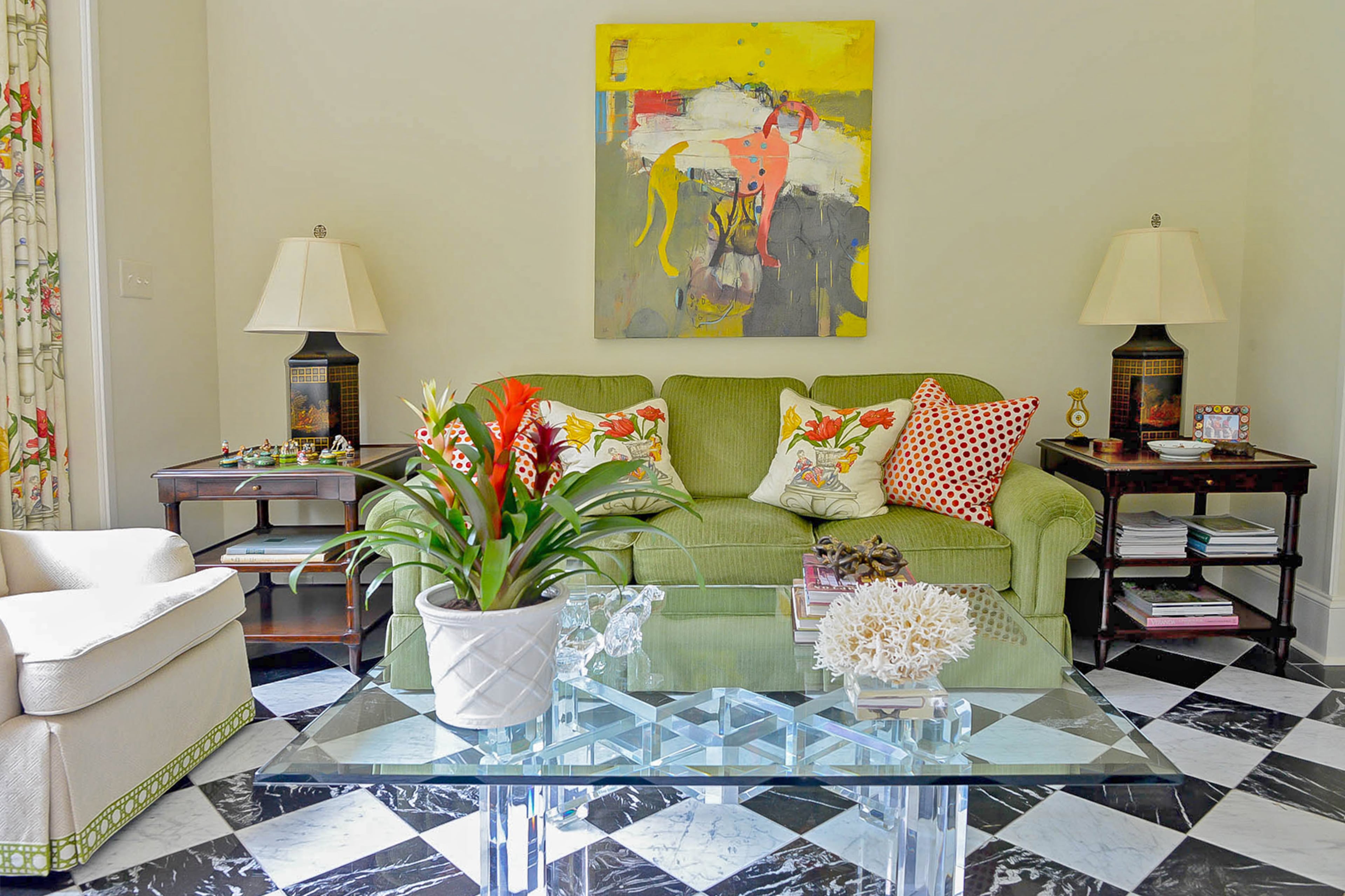 John Banks designed the acrylic cocktail table (sourced through Grizzel & Mann at ADAC) for his garden room, while the transitional artwork of a dog above the sofa is from Lagerquist Gallery.