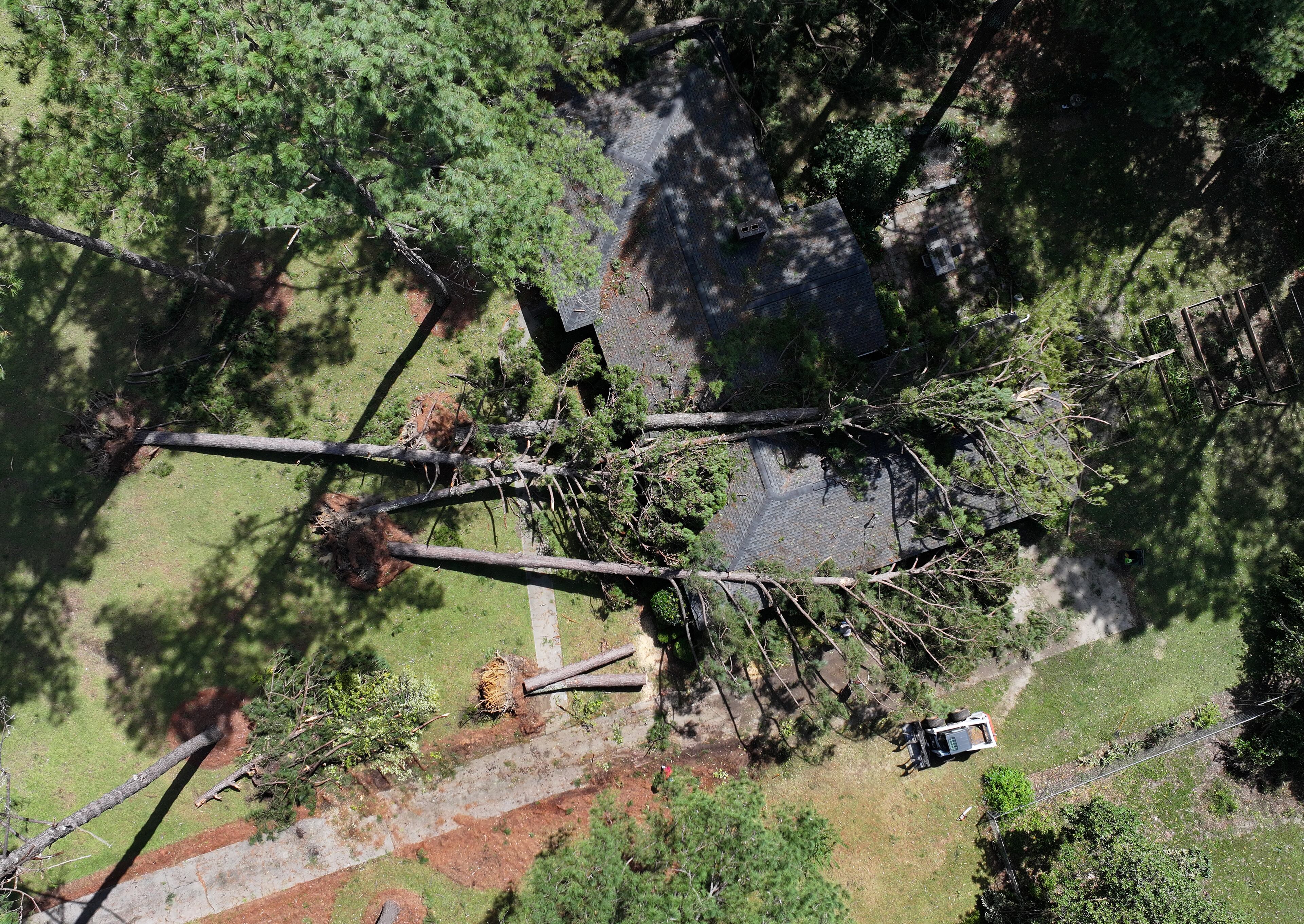 Crew cleans up fallen trees, where a man was killed by fallen trees caused by Hurricane Helene, Friday, September 27, 2024 in Dublin. Fast-moving Helene, which entered Georgia as a Category 2 hurricane Friday morning, continues its powerful march toward metro Atlanta. The storm, which made landfall as a Category 4 in Florida’s Big Bend region Thursday night with maximum sustained winds of 140 mph, continues to pack a dangerous punch and is responsible for at least three deaths in Georgia. Helene’s sustained winds are now at 70 mph, making it a tropical storm status, and it is quickly traveling north. (Hyosub Shin / AJC)